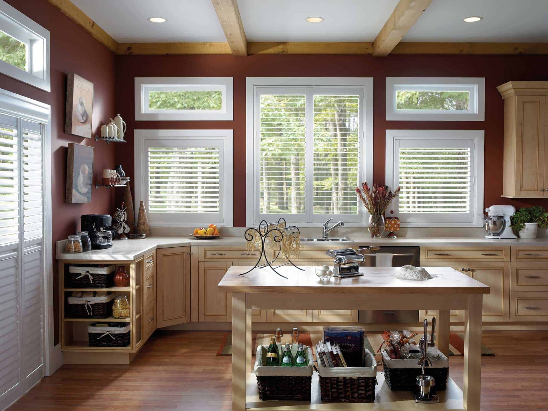 a kitchen with a large island and lots of windows with shutters All Window Decor (817) 448-3393