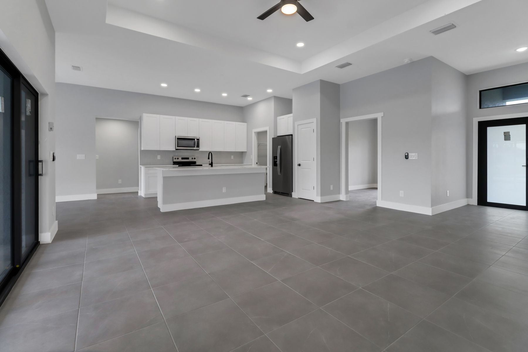 a kitchen with granite counter tops and white cabinets