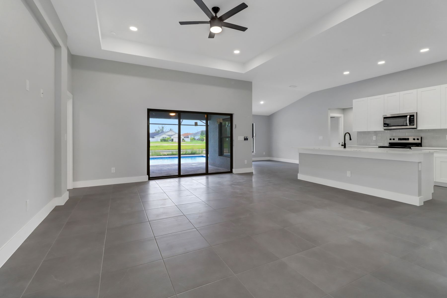 there is a ceiling fan in the living room and a kitchen .