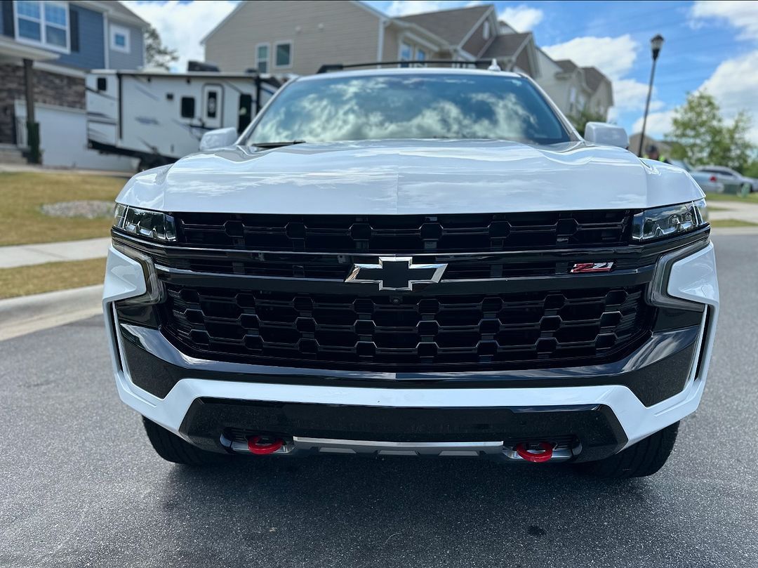 Front view of a black Chevrolet SUV parked on a residential street