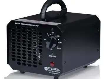Black portable electric heater with handle, front grille, and control dial