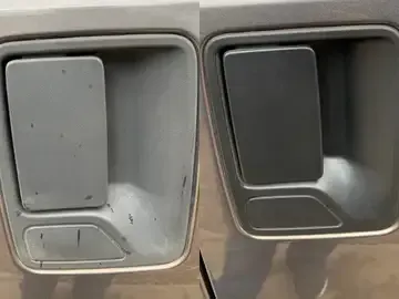 Close-up of two car interior door handles, one gray and one black.