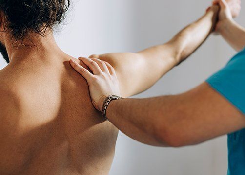 Chiropractor Doing Shoulder Adjustment — Wichita, KS — Advanced Chiropractic Chiropractor Doing Shoulder Adjustment — Wichita, KS — Advanced Chiropractic