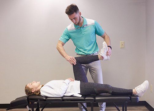 Massaging Left Knee — Wichita, KS — Advanced Chiropractic Massaging Left Knee — Wichita, KS — Advanced Chiropractic