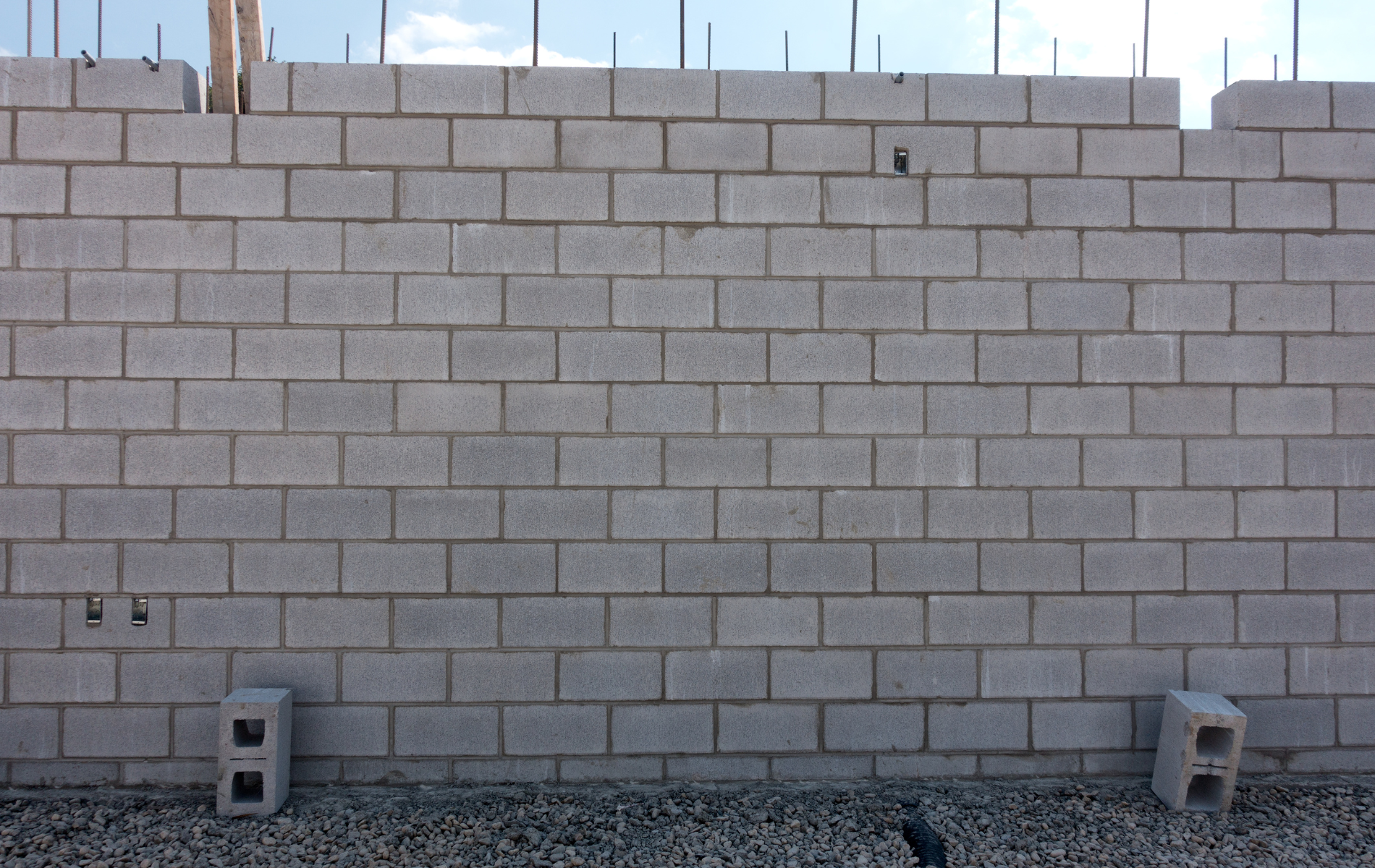 A brick wall is being built with the letter b in the middle