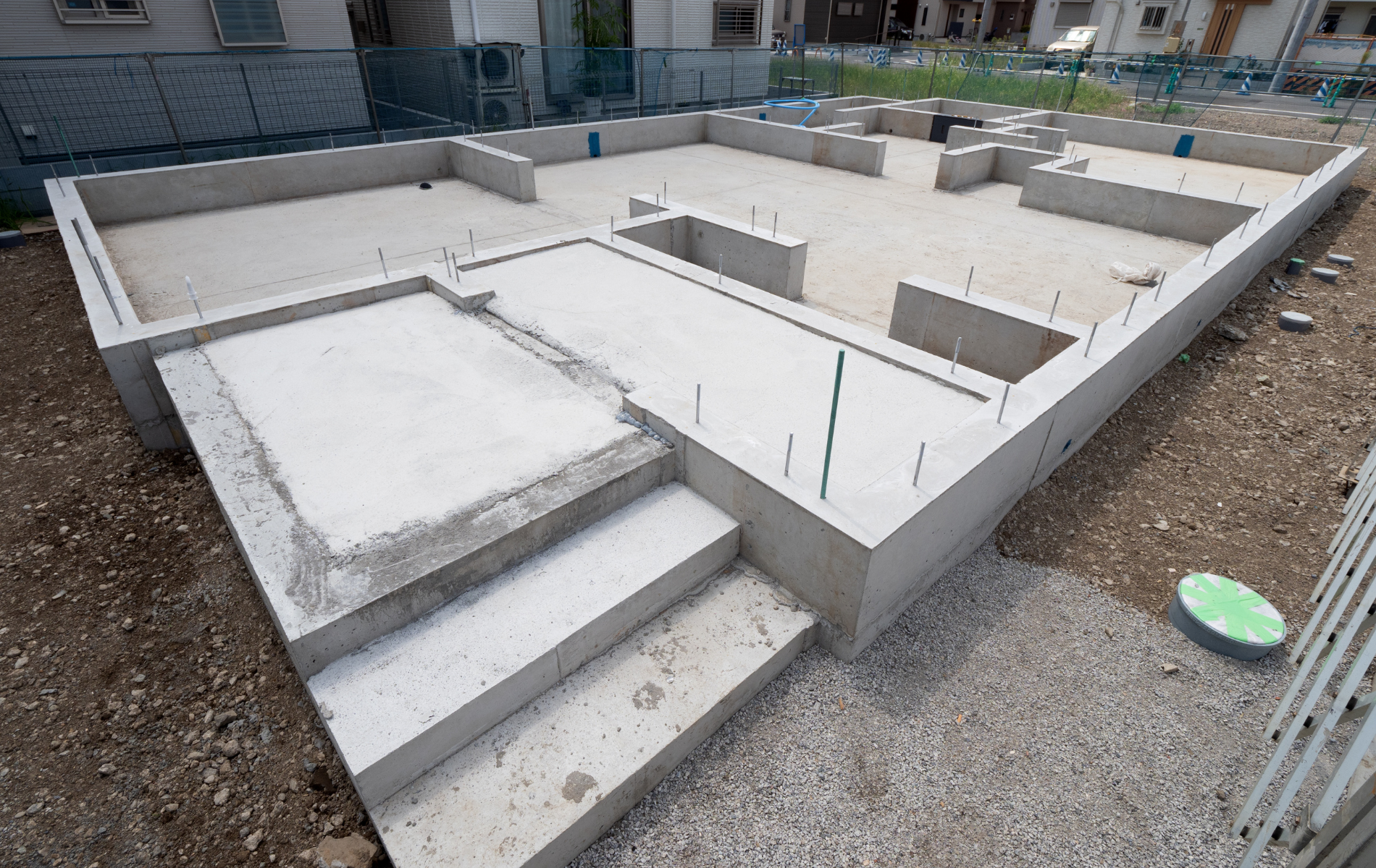 A concrete base of a house under construction with stairs.