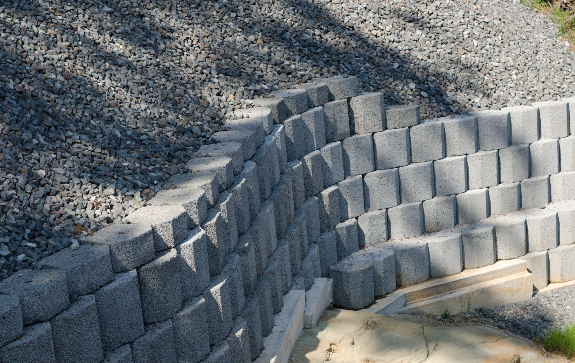 A brick wall is being built next to a gravel path