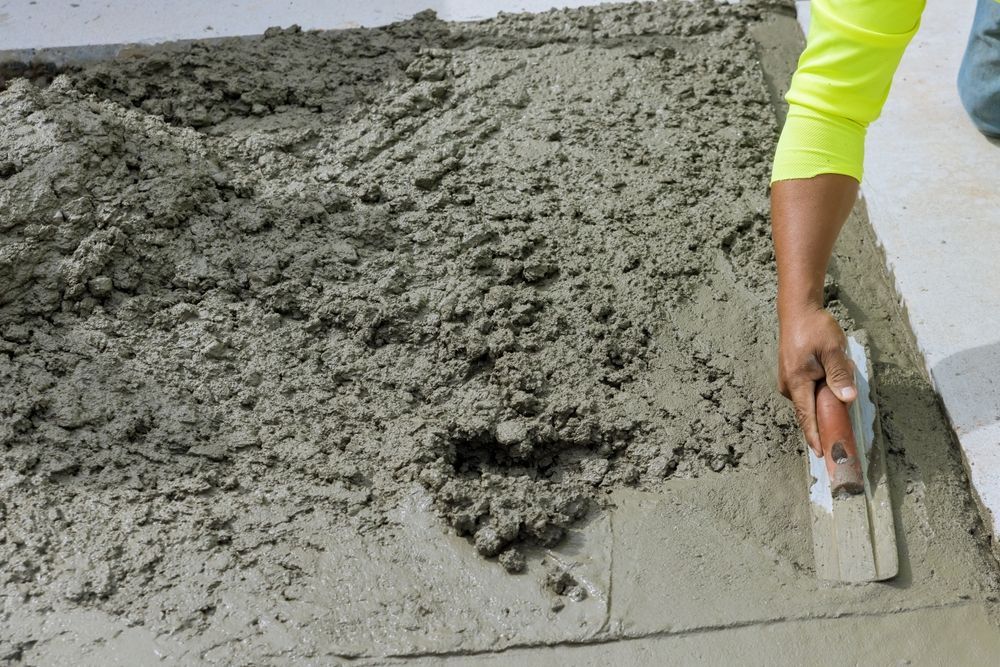 Person Smoothing Wet Concrete — Lunny's Carpentry In Dubbo, NSW