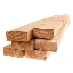 Stack of rectangular wooden planks, light brown color, showing wood grain.