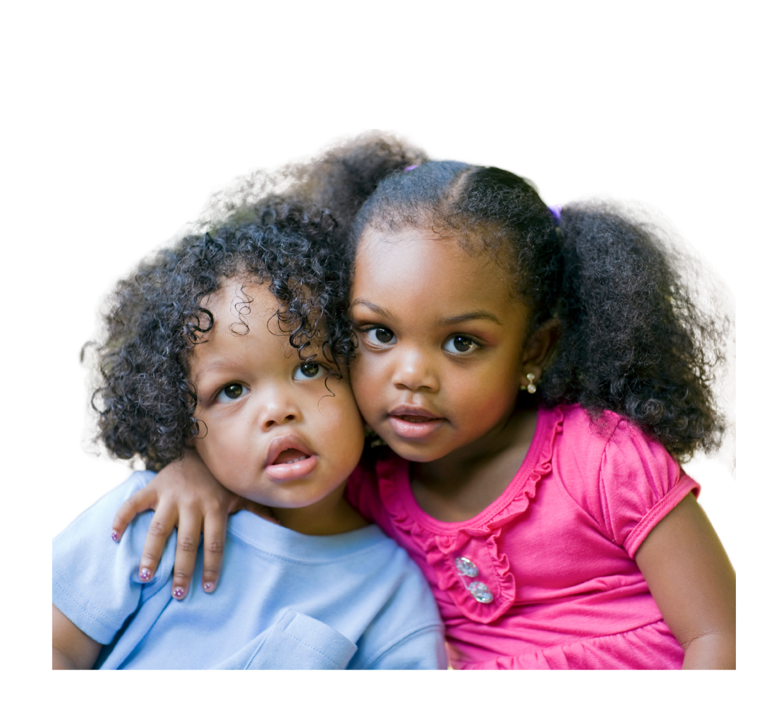 Two little girls sitting next to each other on a white background