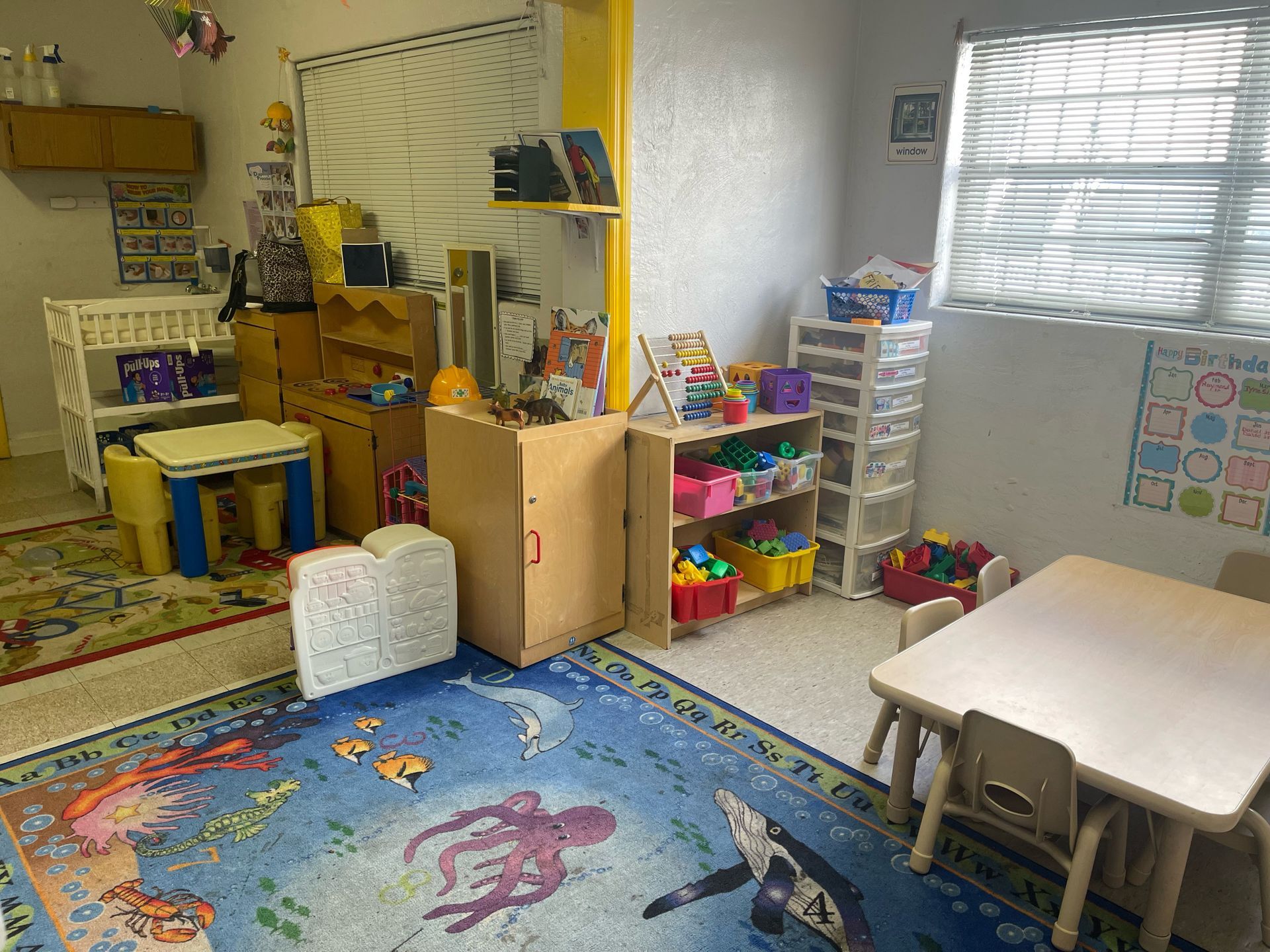 A room filled with lots of toys and tables and chairs.