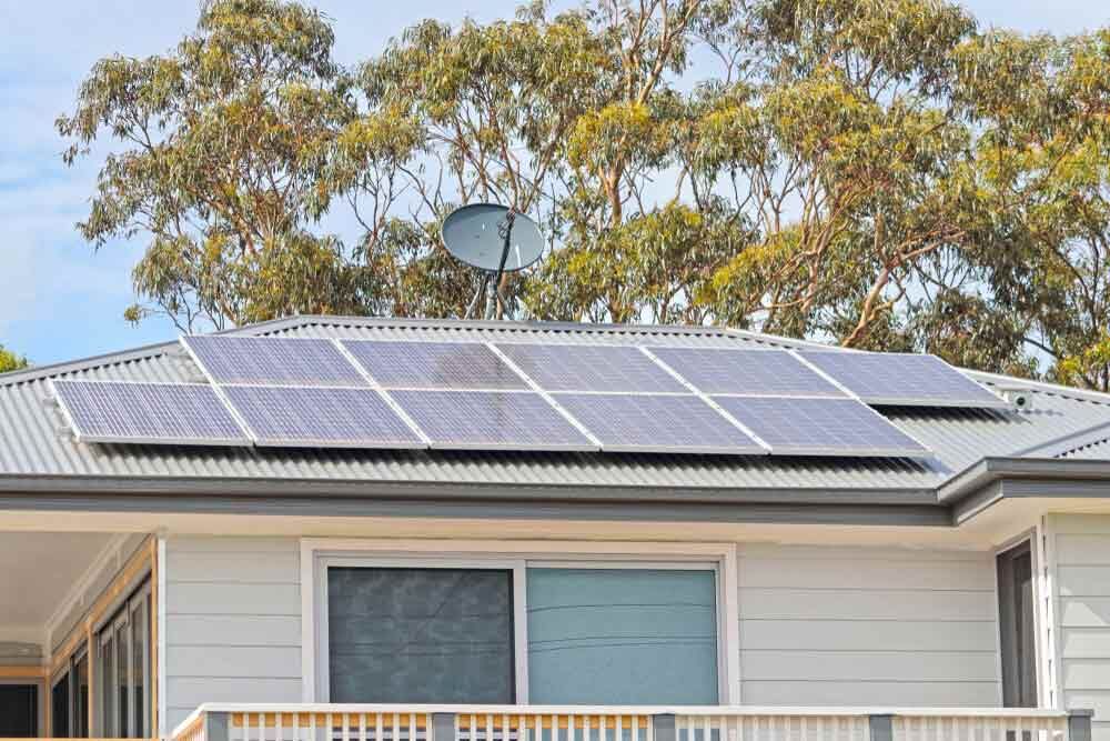 A House With Solar Panels And A Satellite Dish On The Roof — IPOWER Industries In Airlie Beach, QLD
