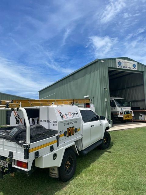 A White Truck Is Parked In Front Of A Building — IPOWER Industries In Airlie Beach, QLD