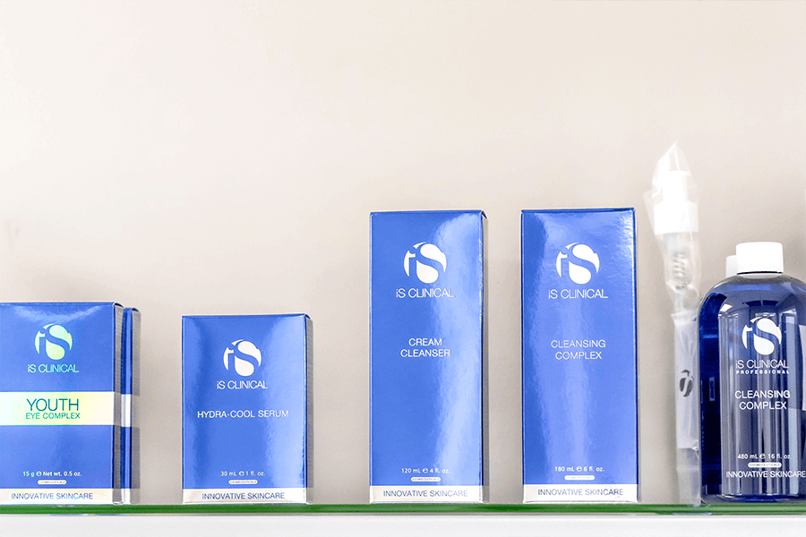 A shelf with a variety of blue boxes and bottles on it.