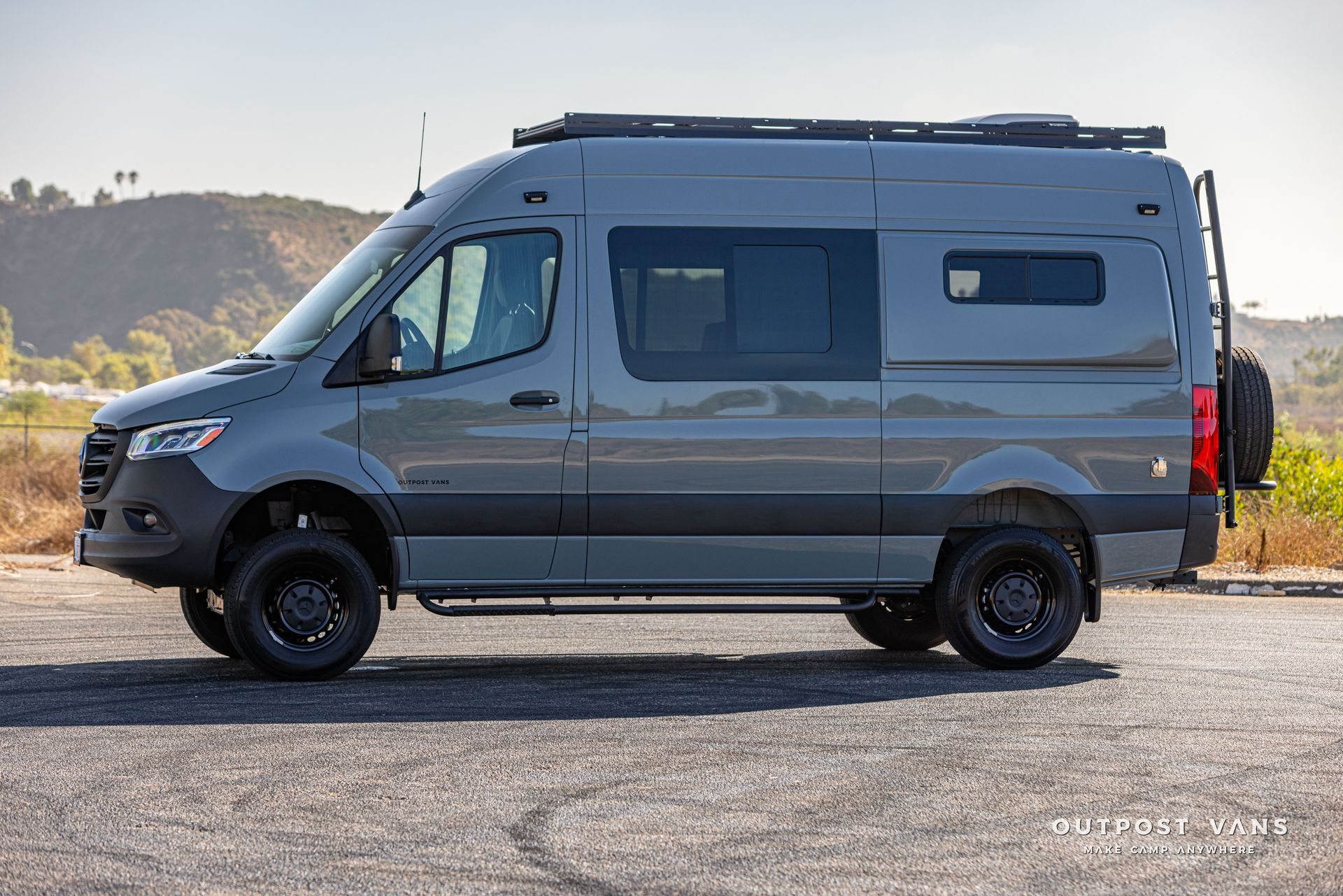 A gray van is parked on the side of the road.