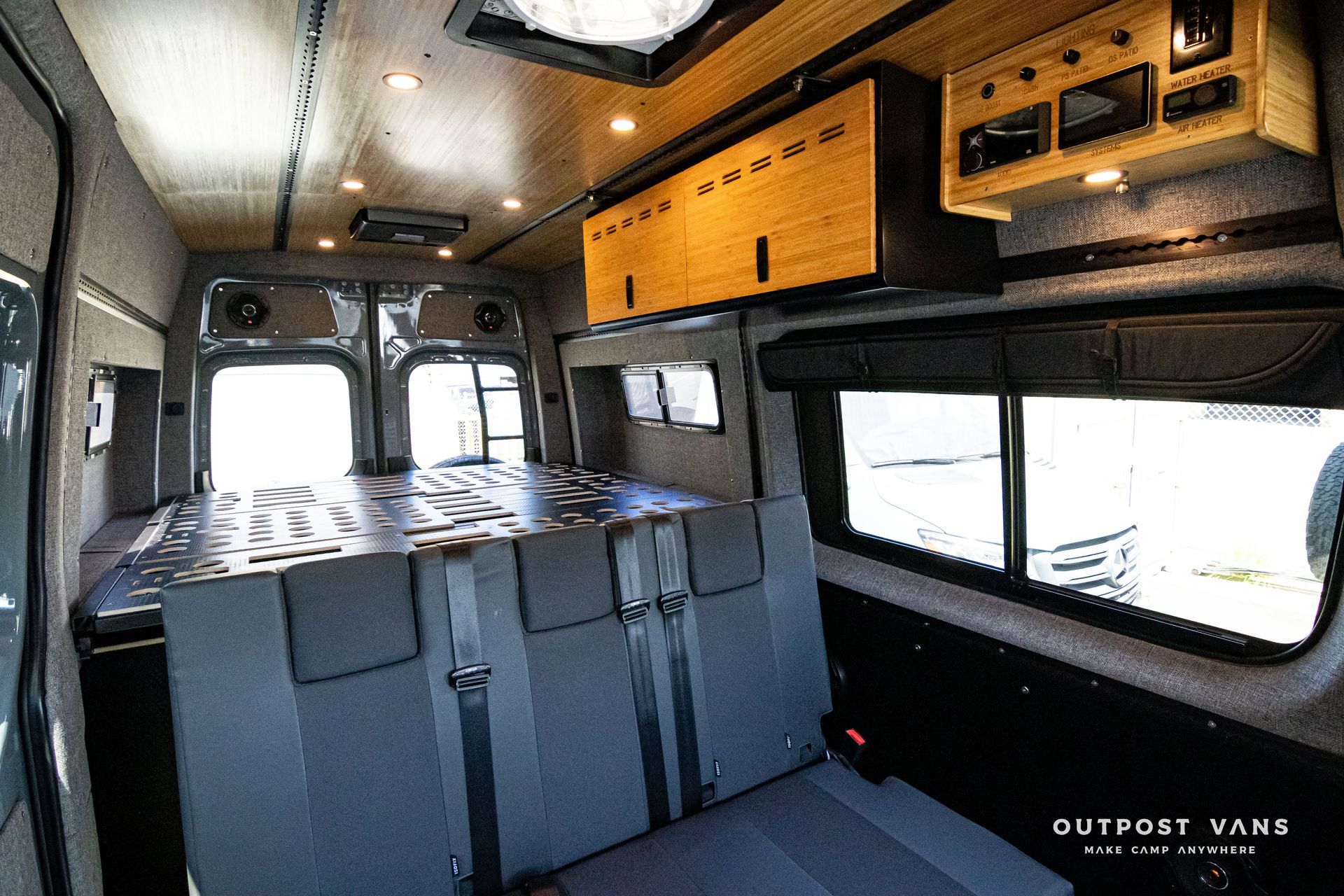 The inside of a van with a bed in the back.