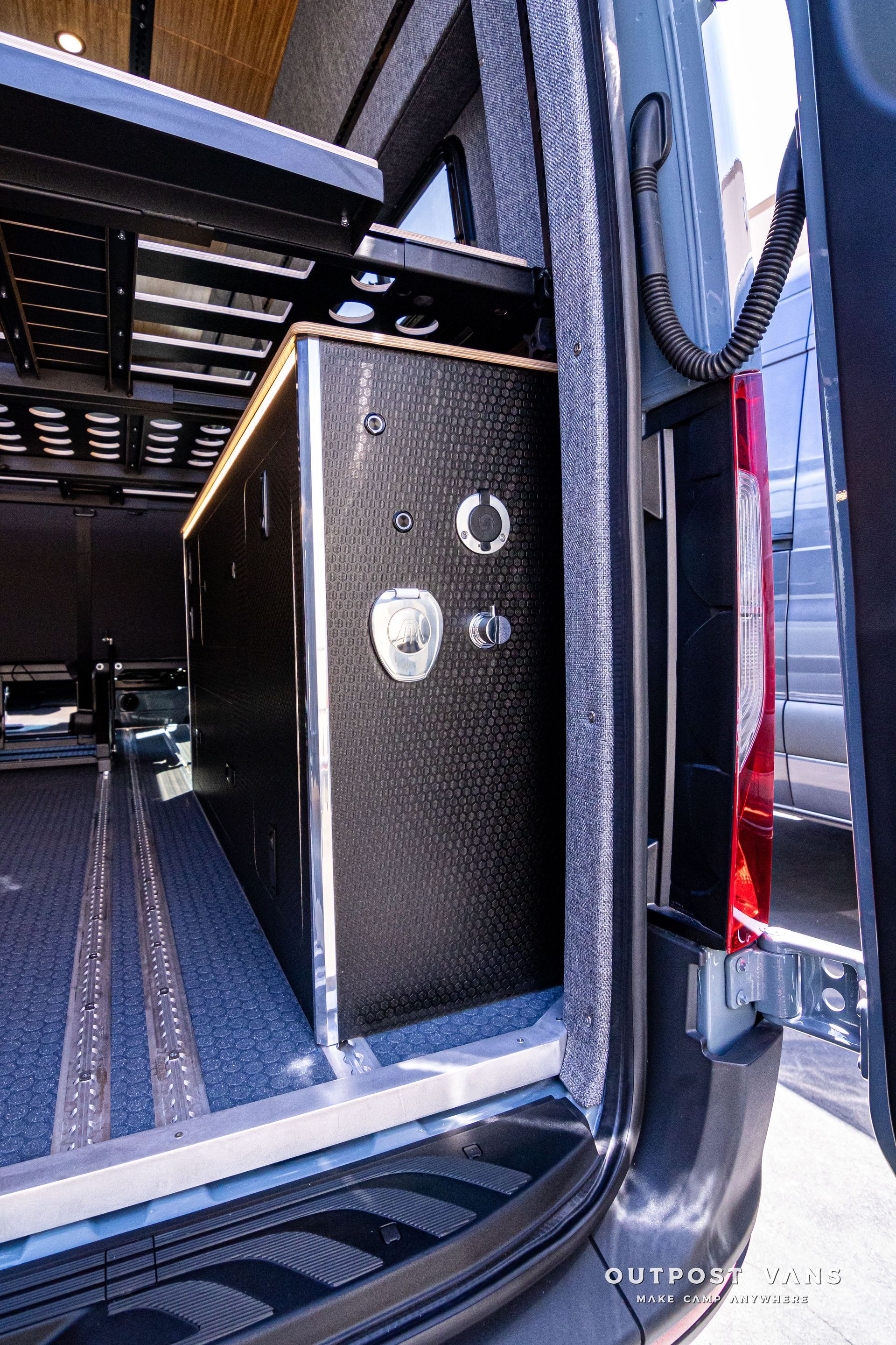 The back of a van with a box in the back of it.