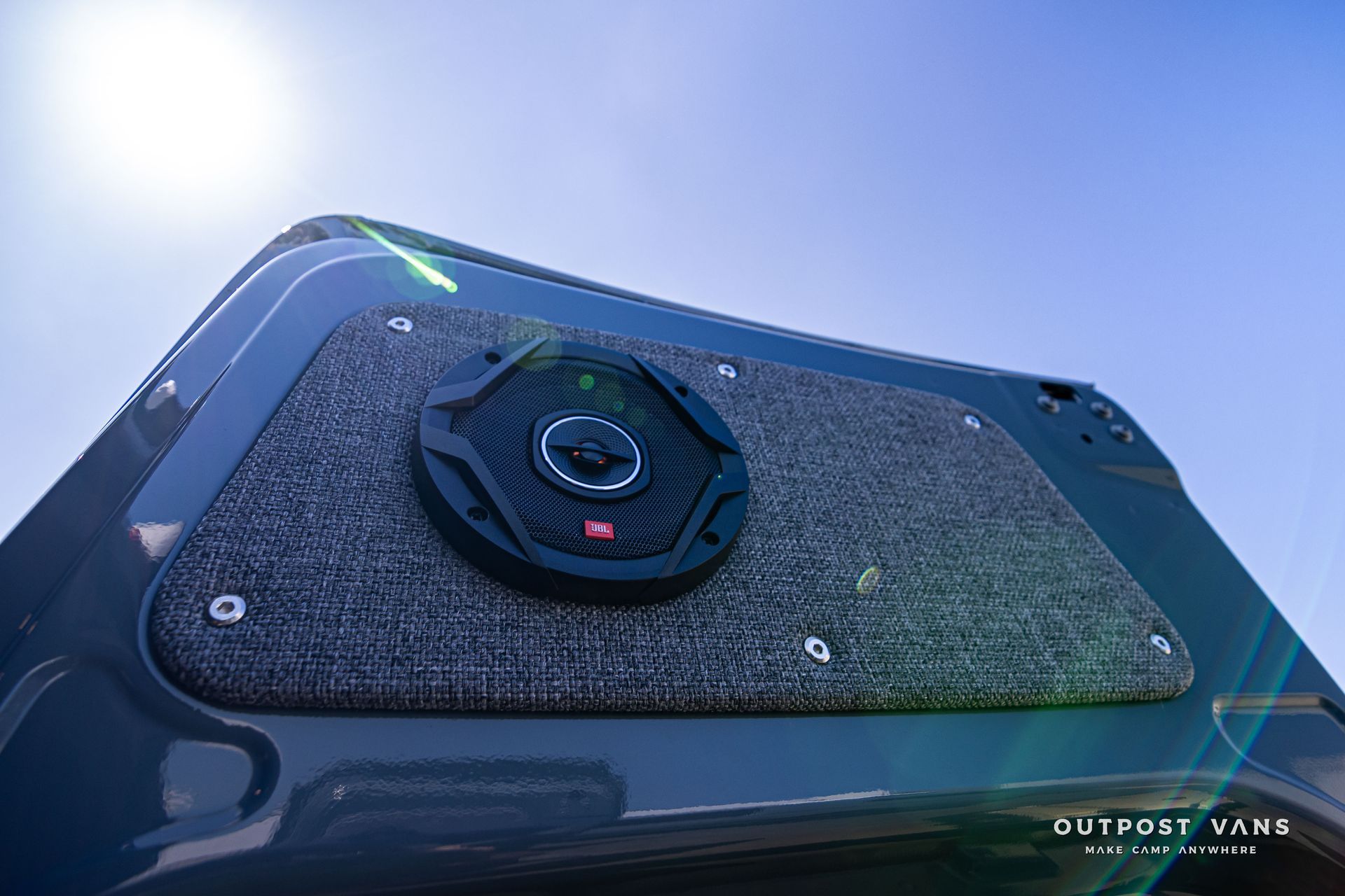 A close up of a speaker on the back of a van.