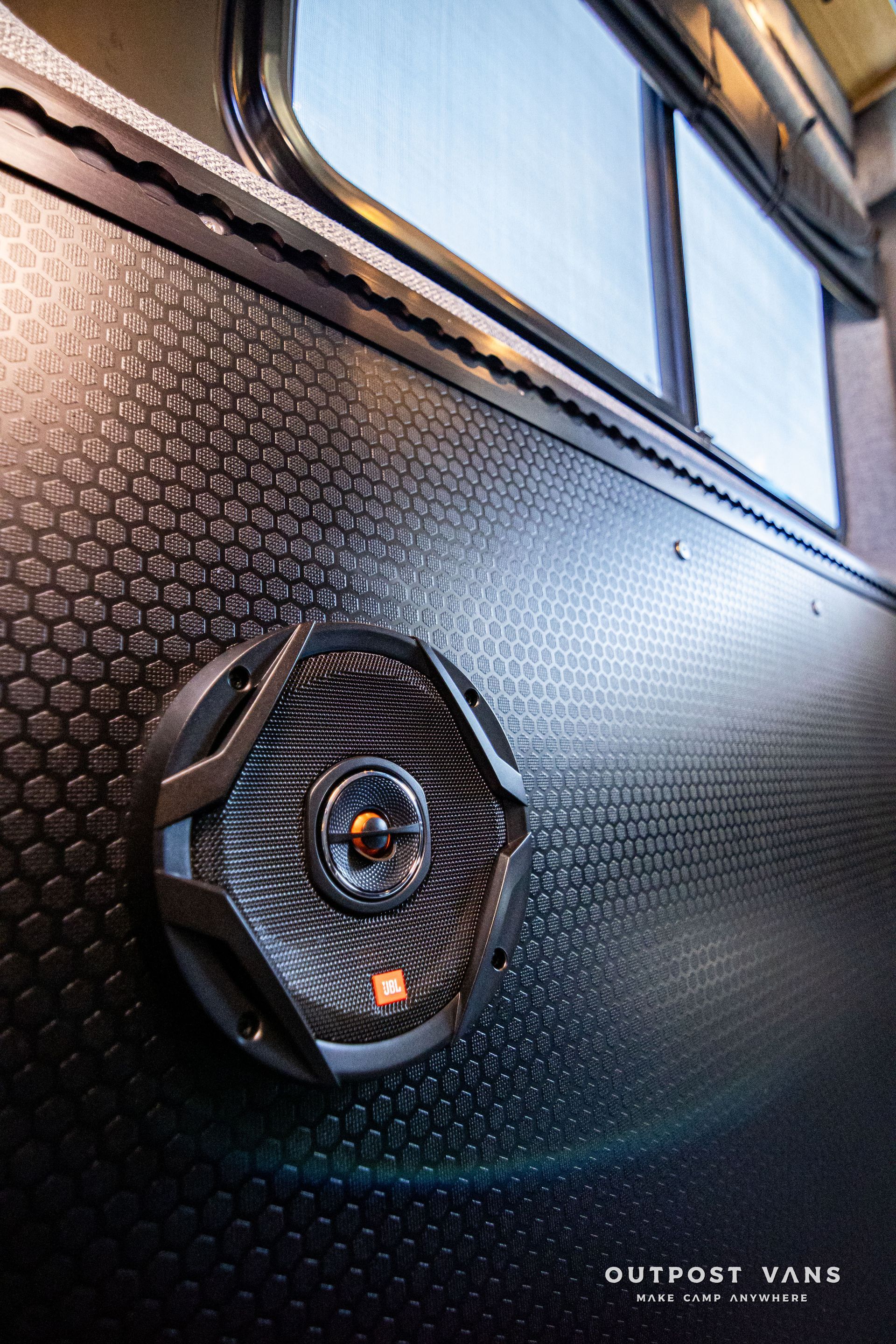 A close up of a speaker on the side of a van
