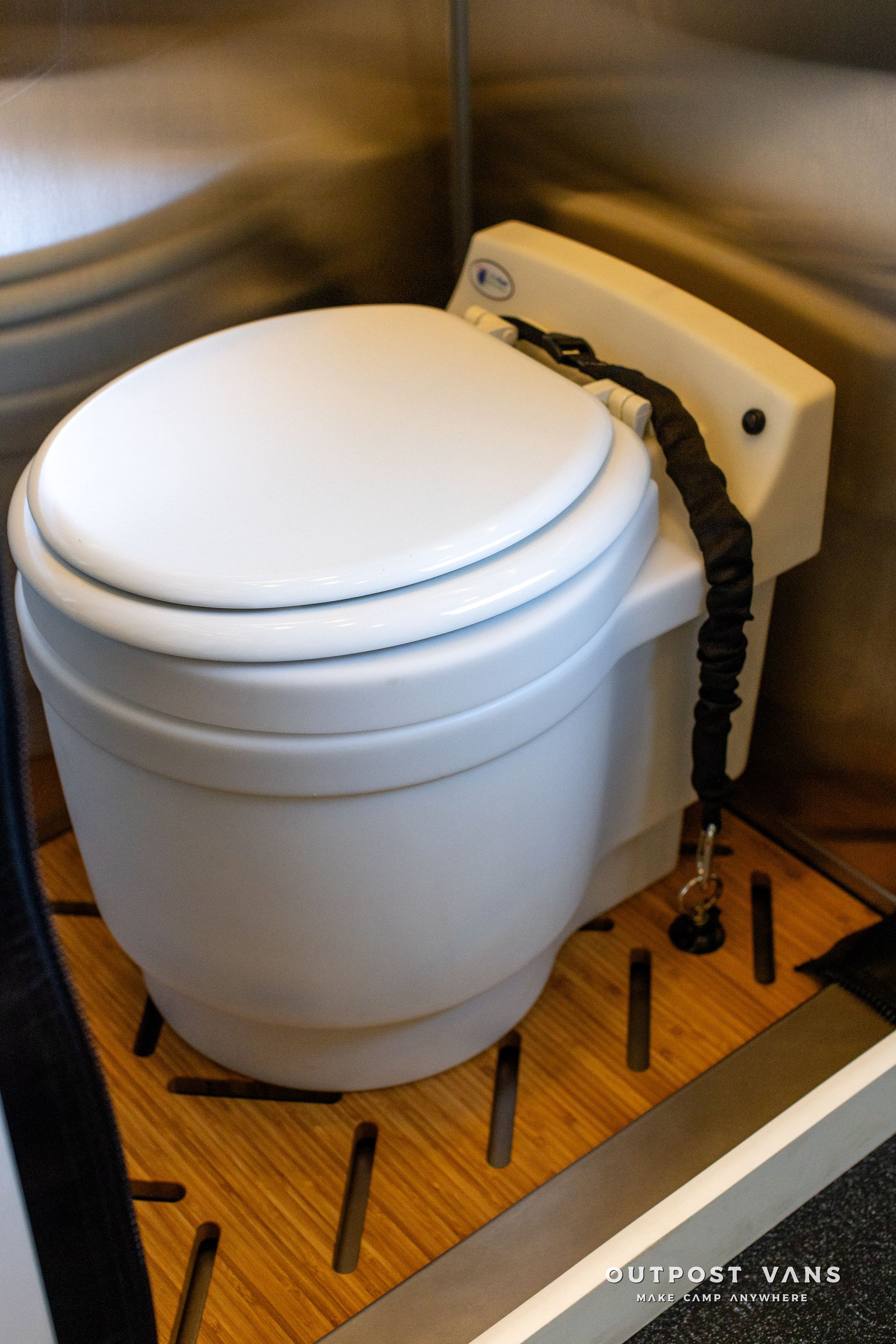 A white toilet with a chain attached to it