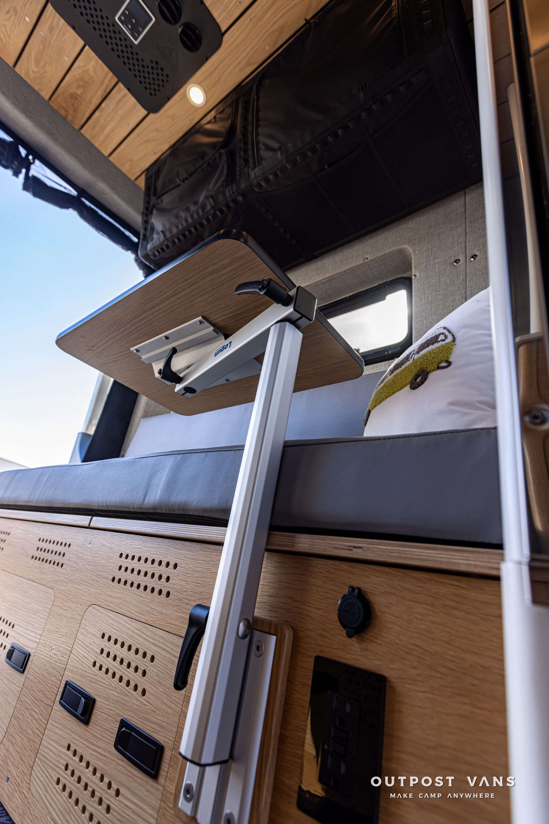 A table is sitting on top of a bed in a van.