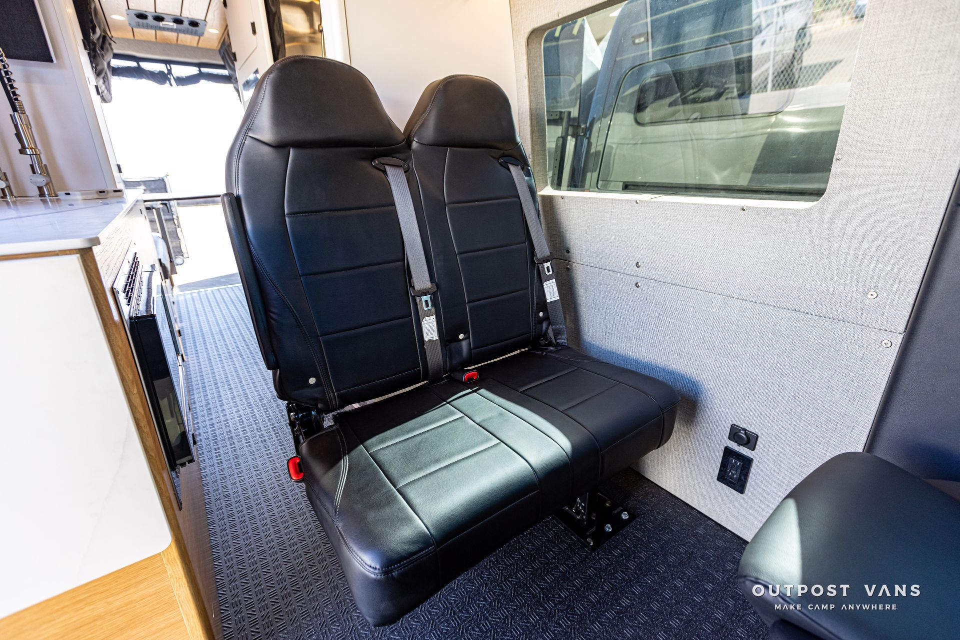 There are two seats in the back of a van.