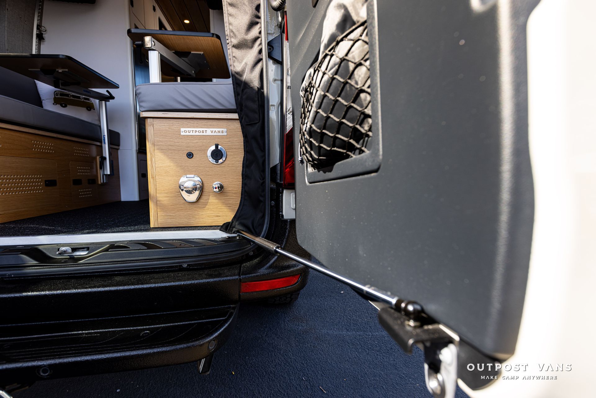 A close up of the back of a van with a rope attached to it.