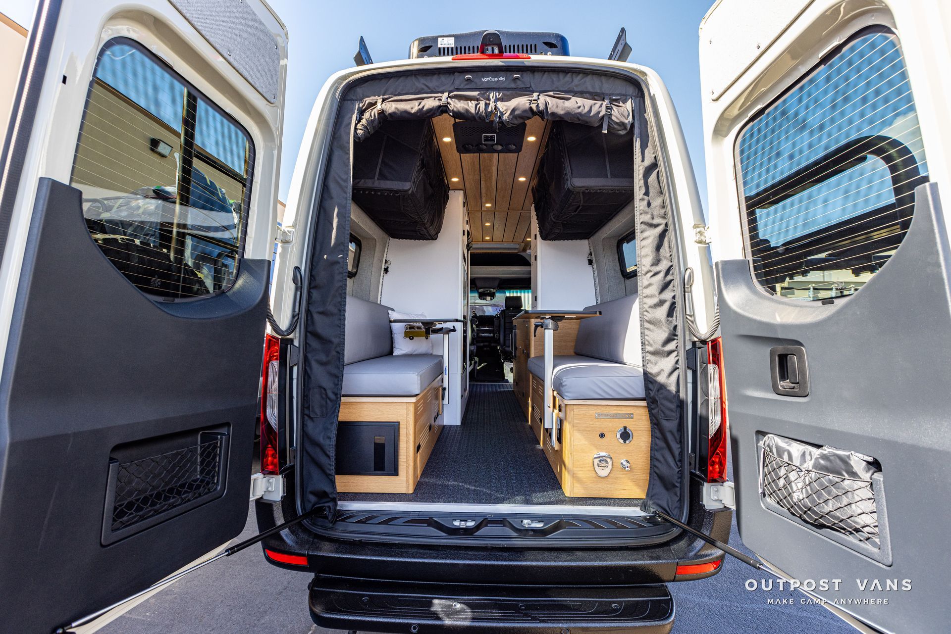 The back of a camper van with its doors open.