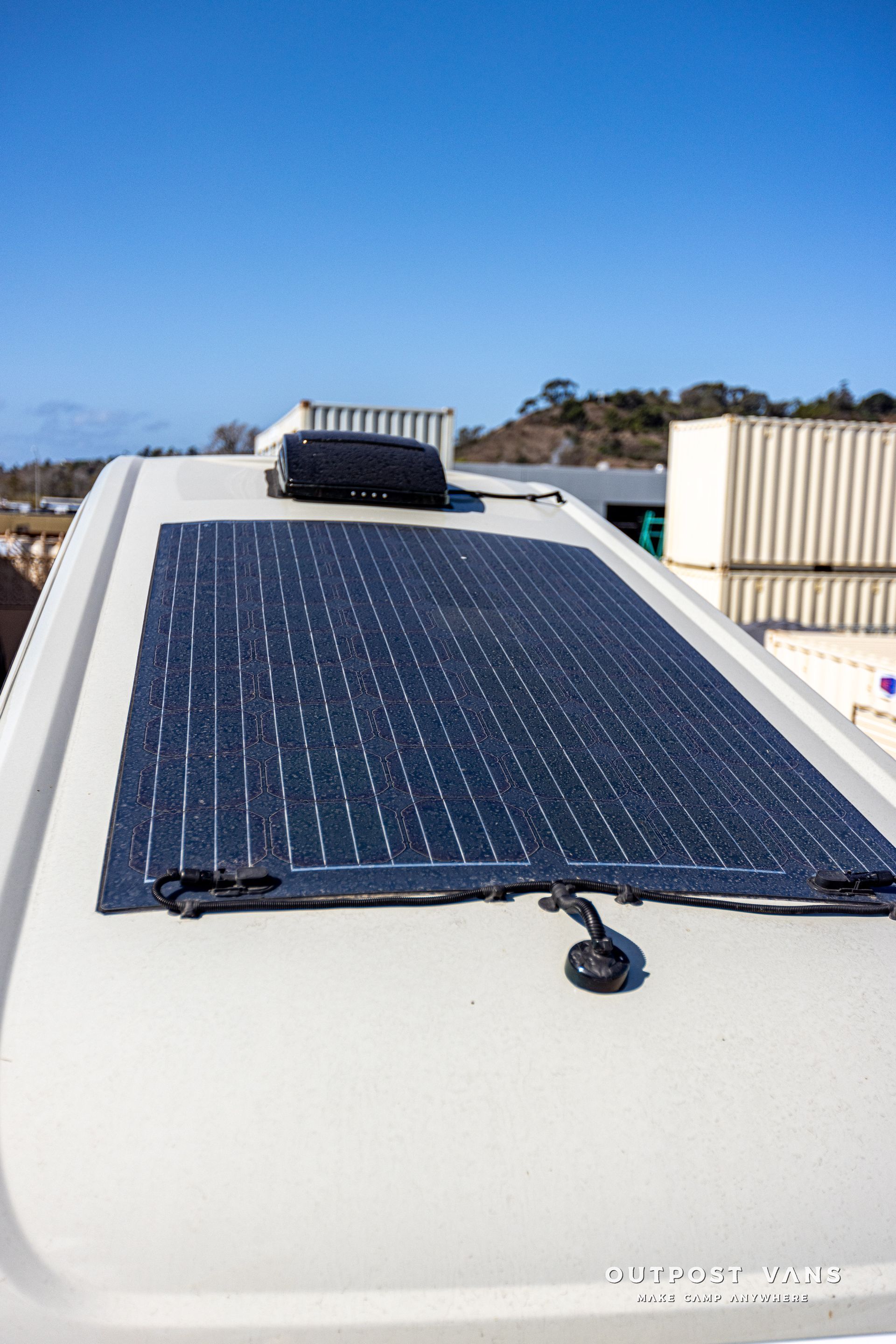 A solar panel is attached to the roof of a van.