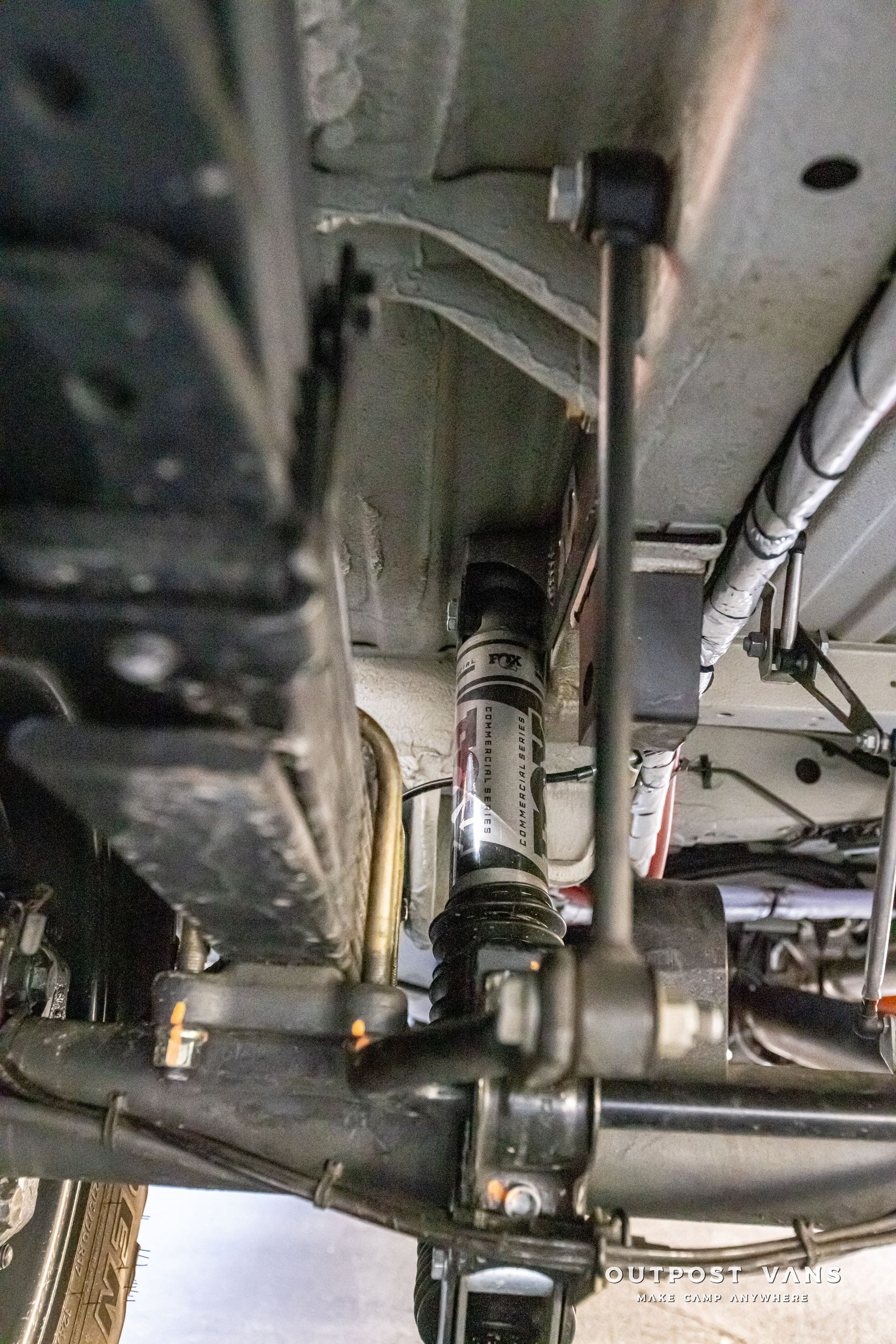 A close up of the underside of a car 's suspension system.