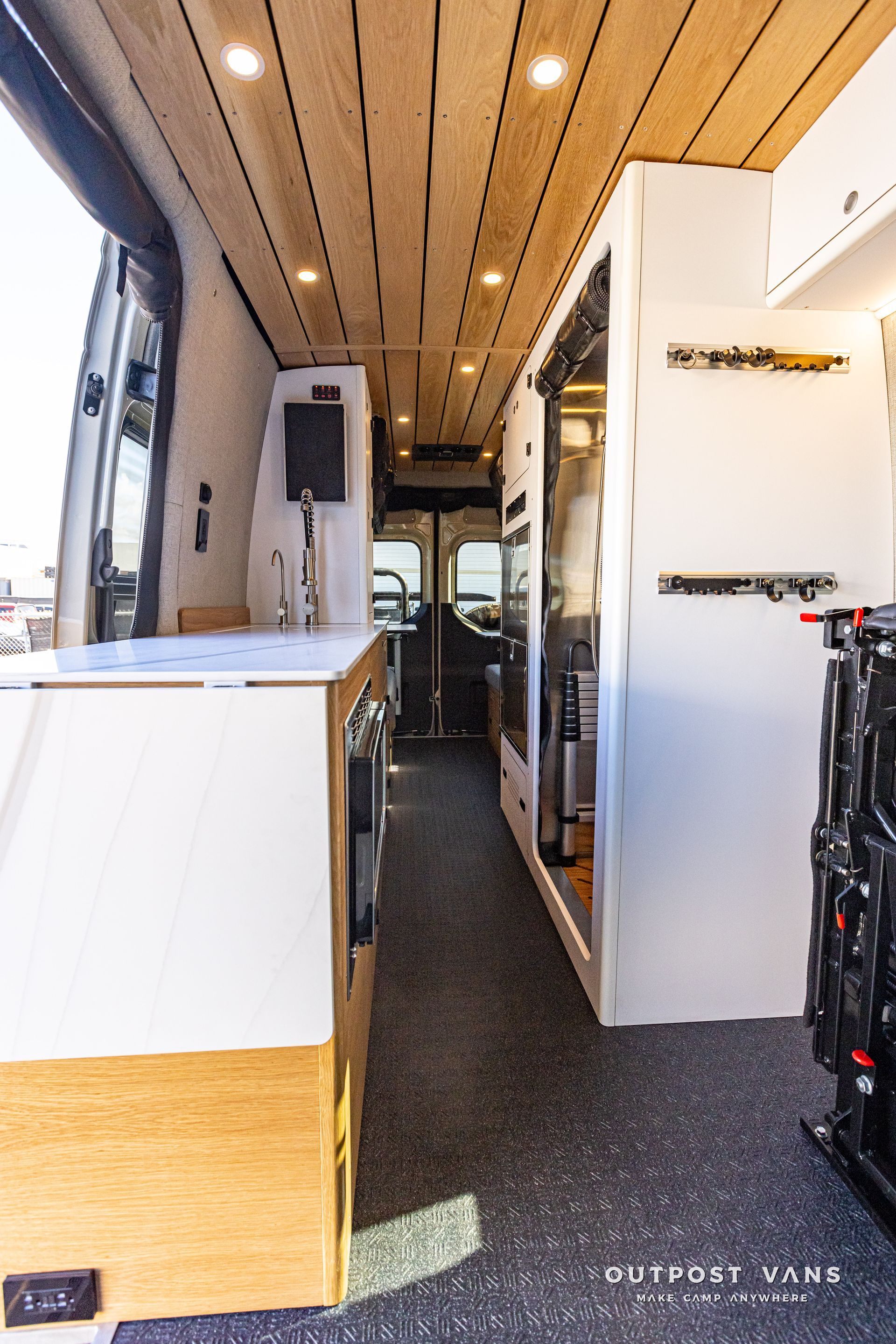 The inside of a camper van with a wooden ceiling.