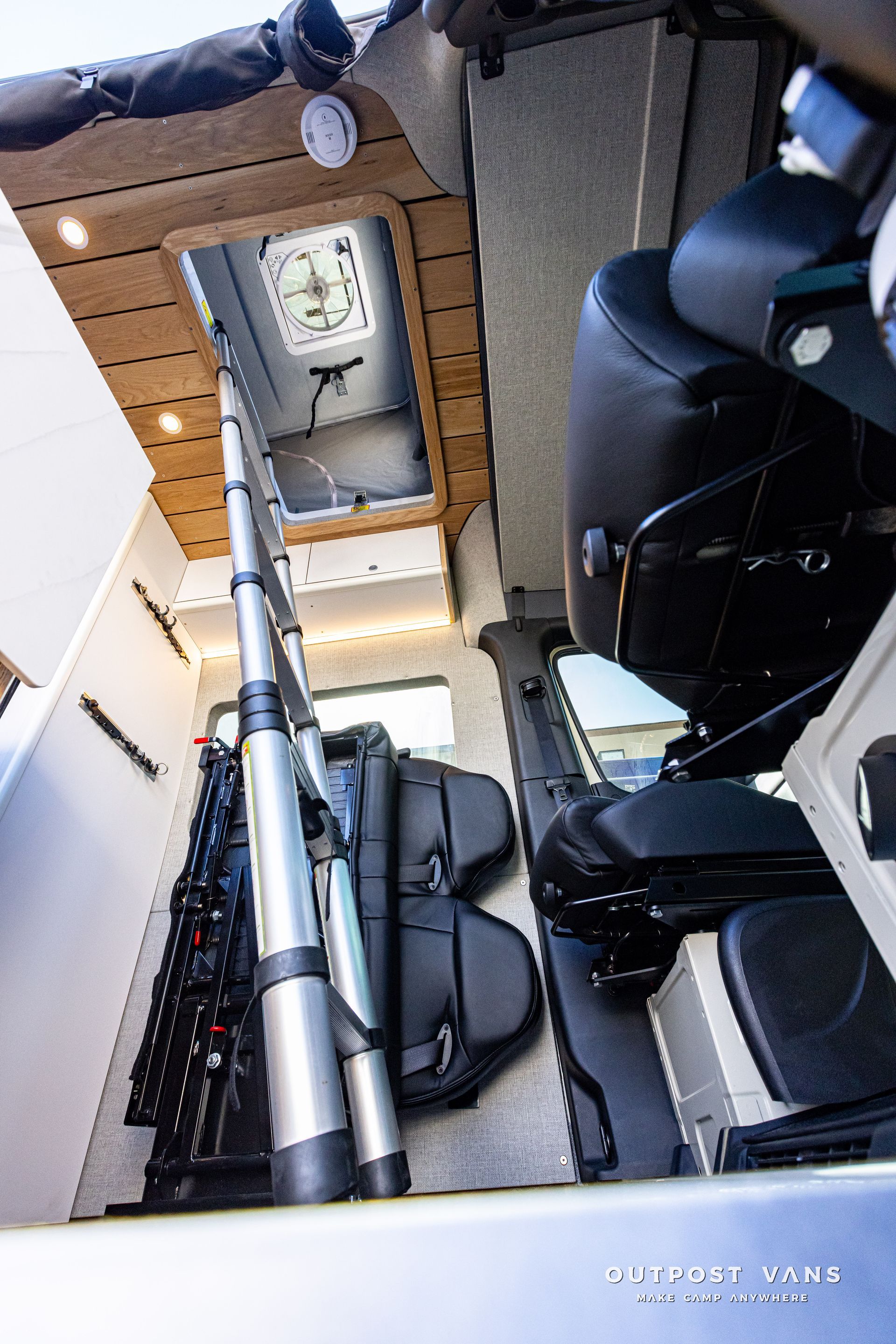 The inside of a van with a clock on the ceiling.