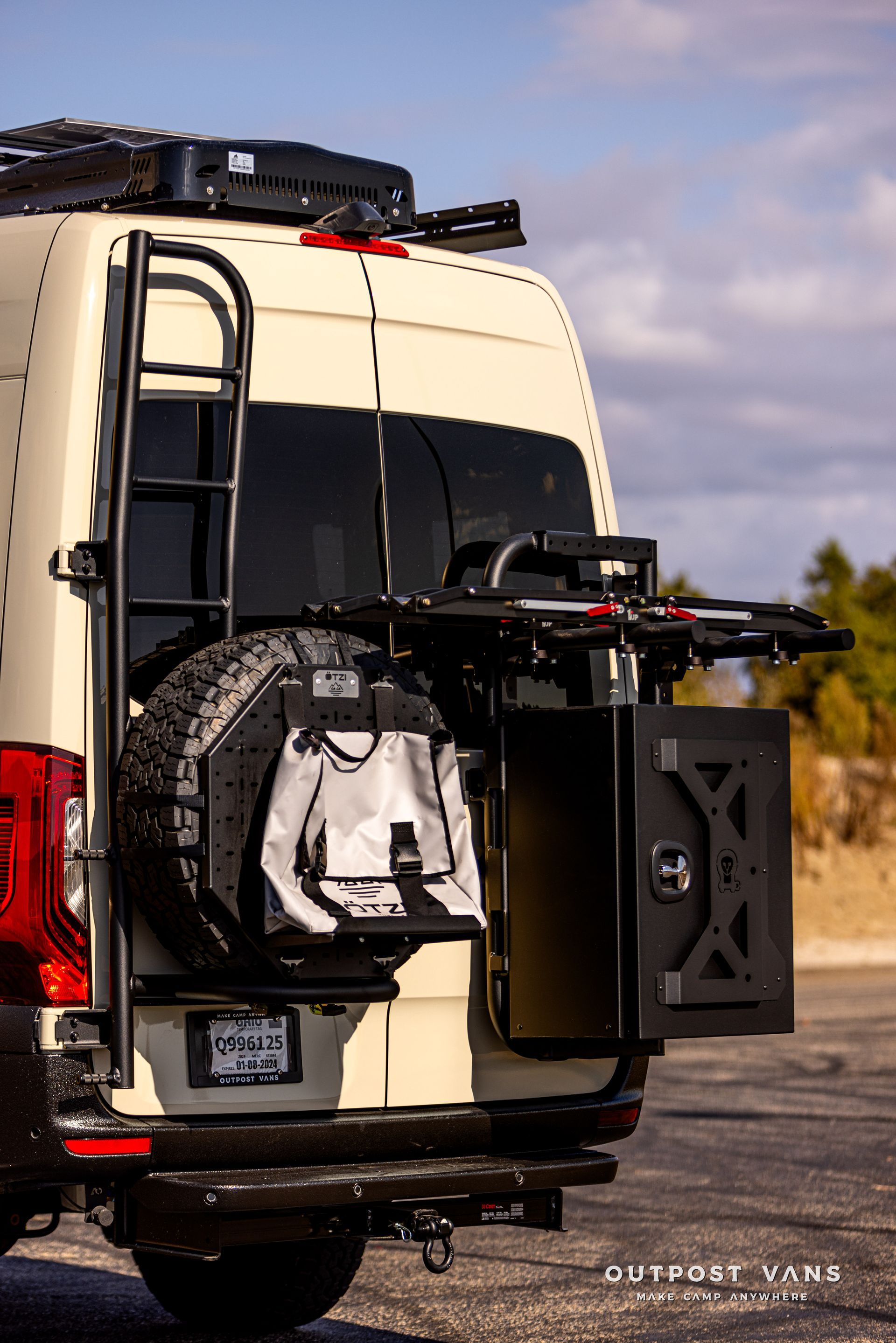 A white van with a ladder attached to the back of it.