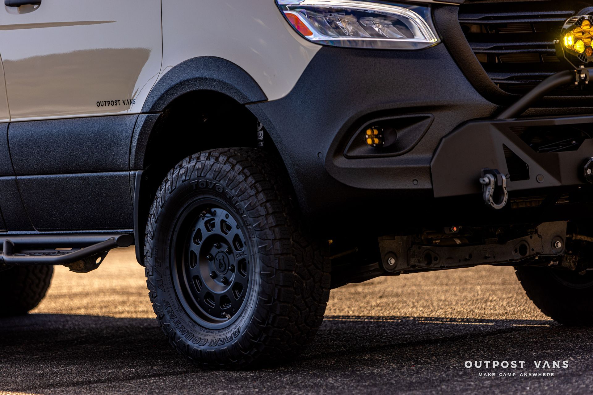 A white van with black fender flares and black tires