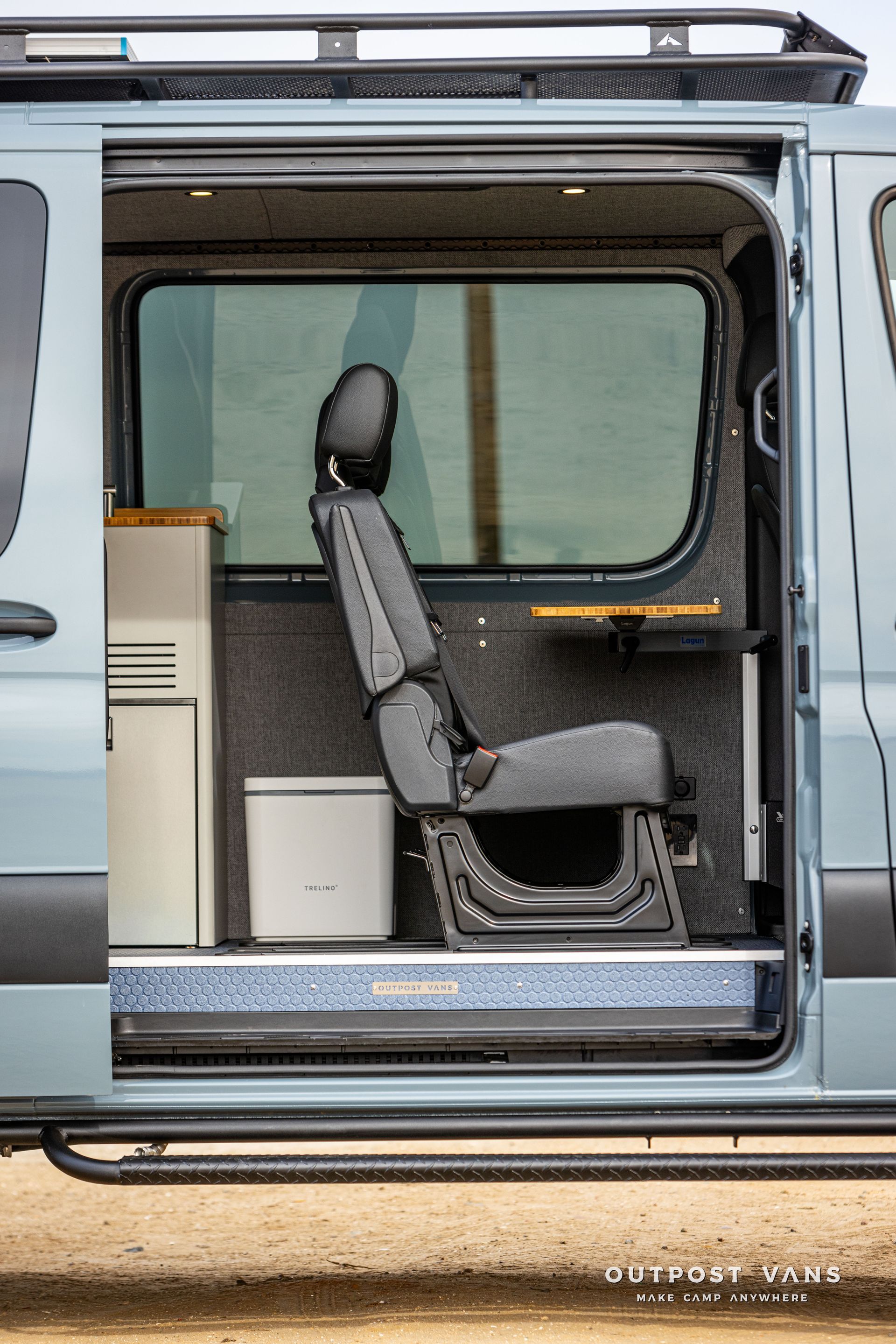 A van with the door open and a seat in the back.