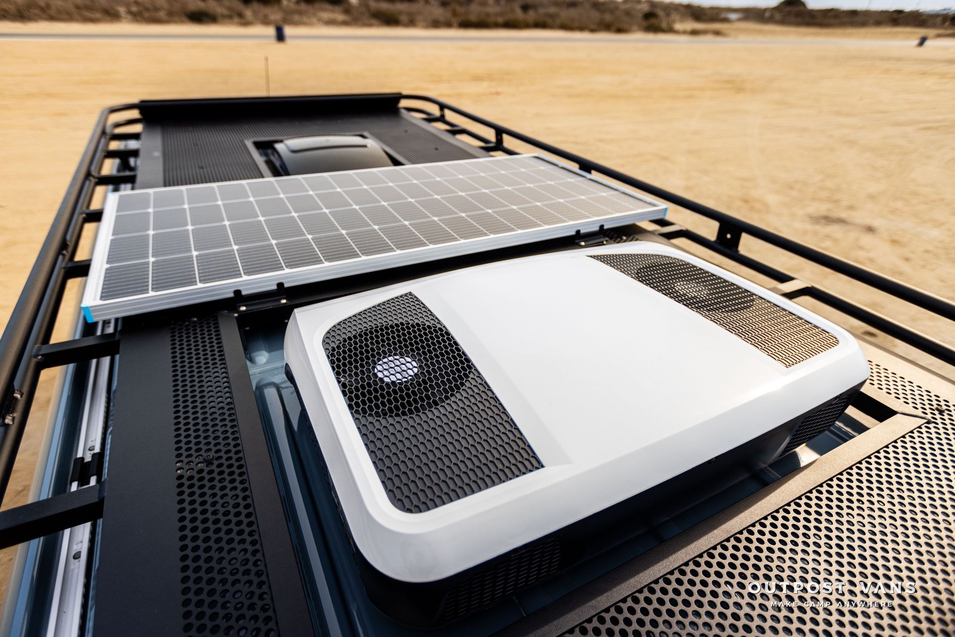 A van with a solar panel and a fan on the roof.