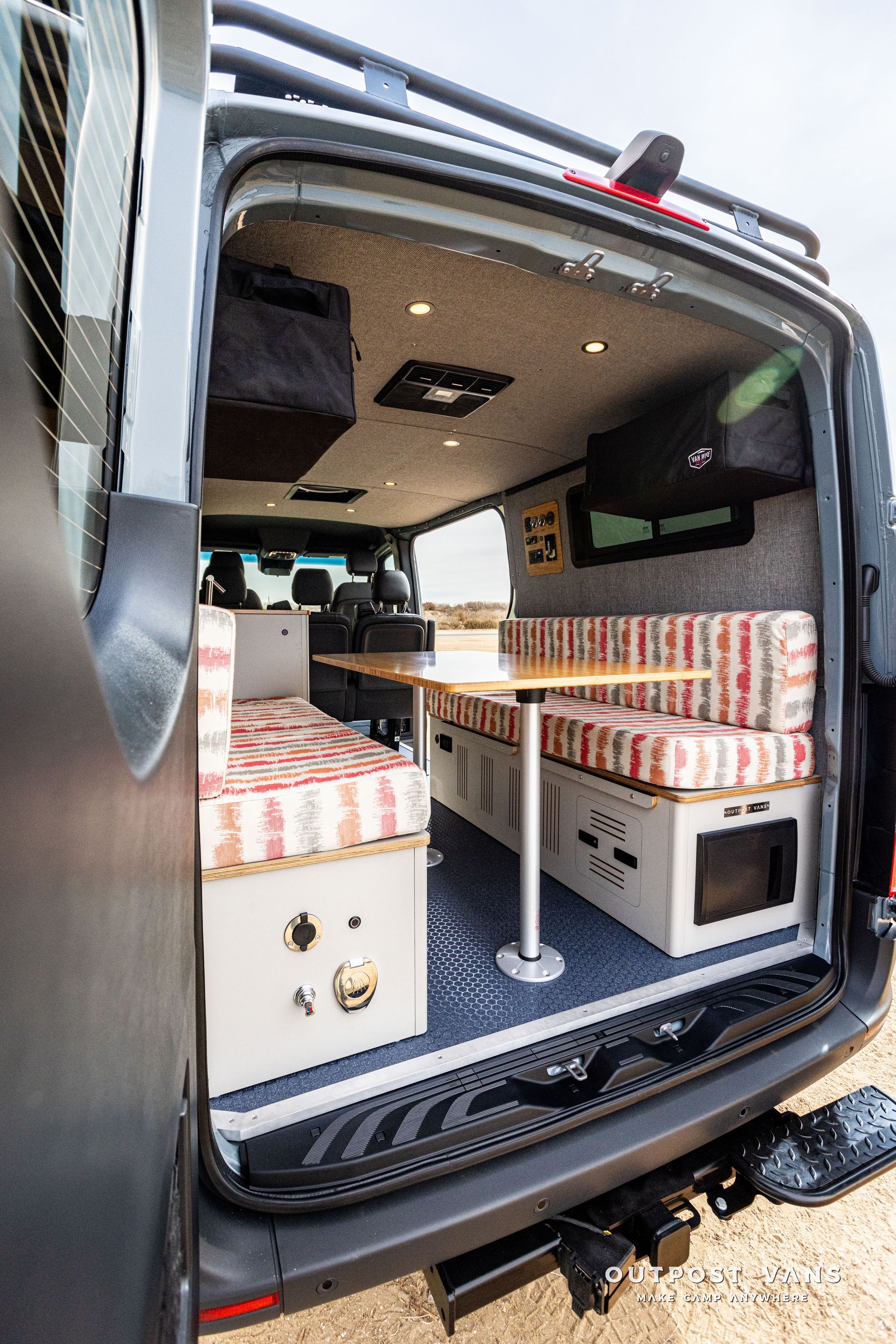 The back of a camper van with the door open.