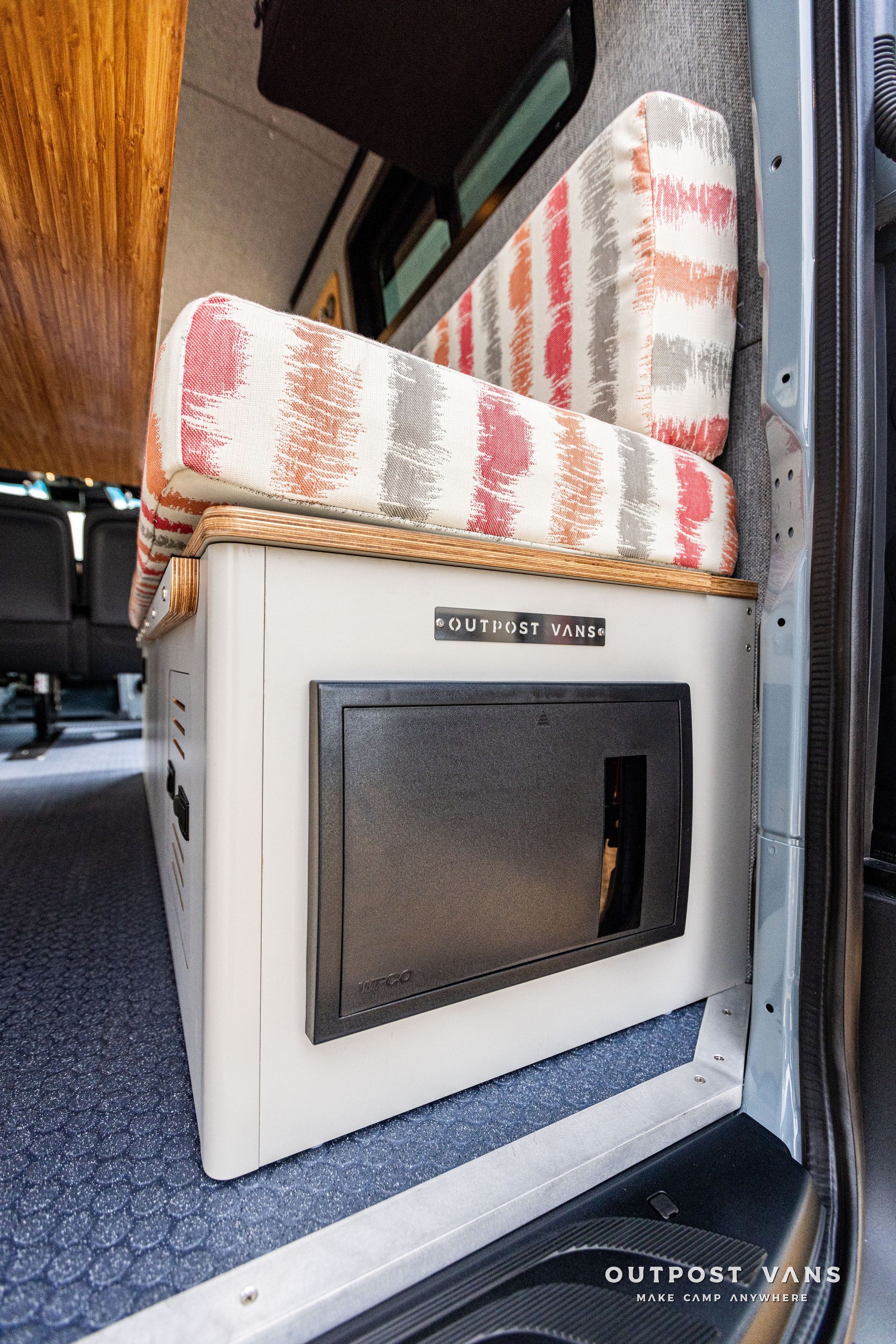 A van with a couch and a microwave in the back.
