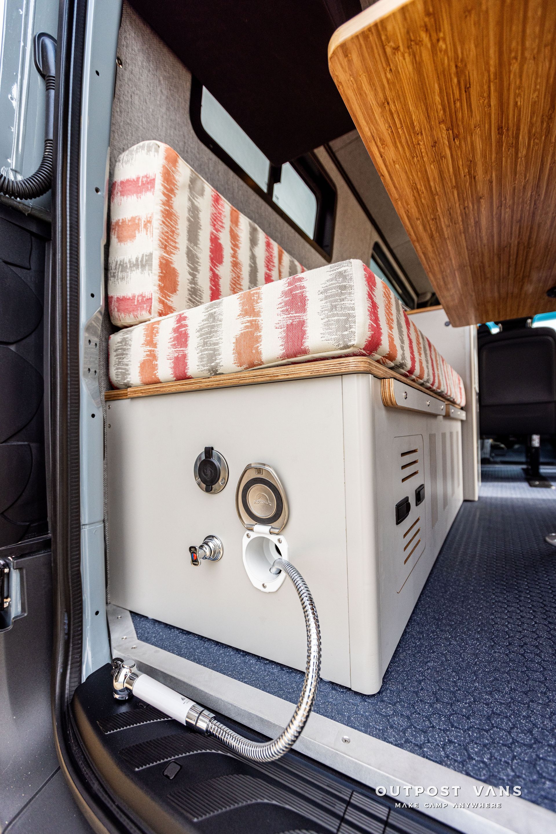 A camper van with a couch and a table in the back.