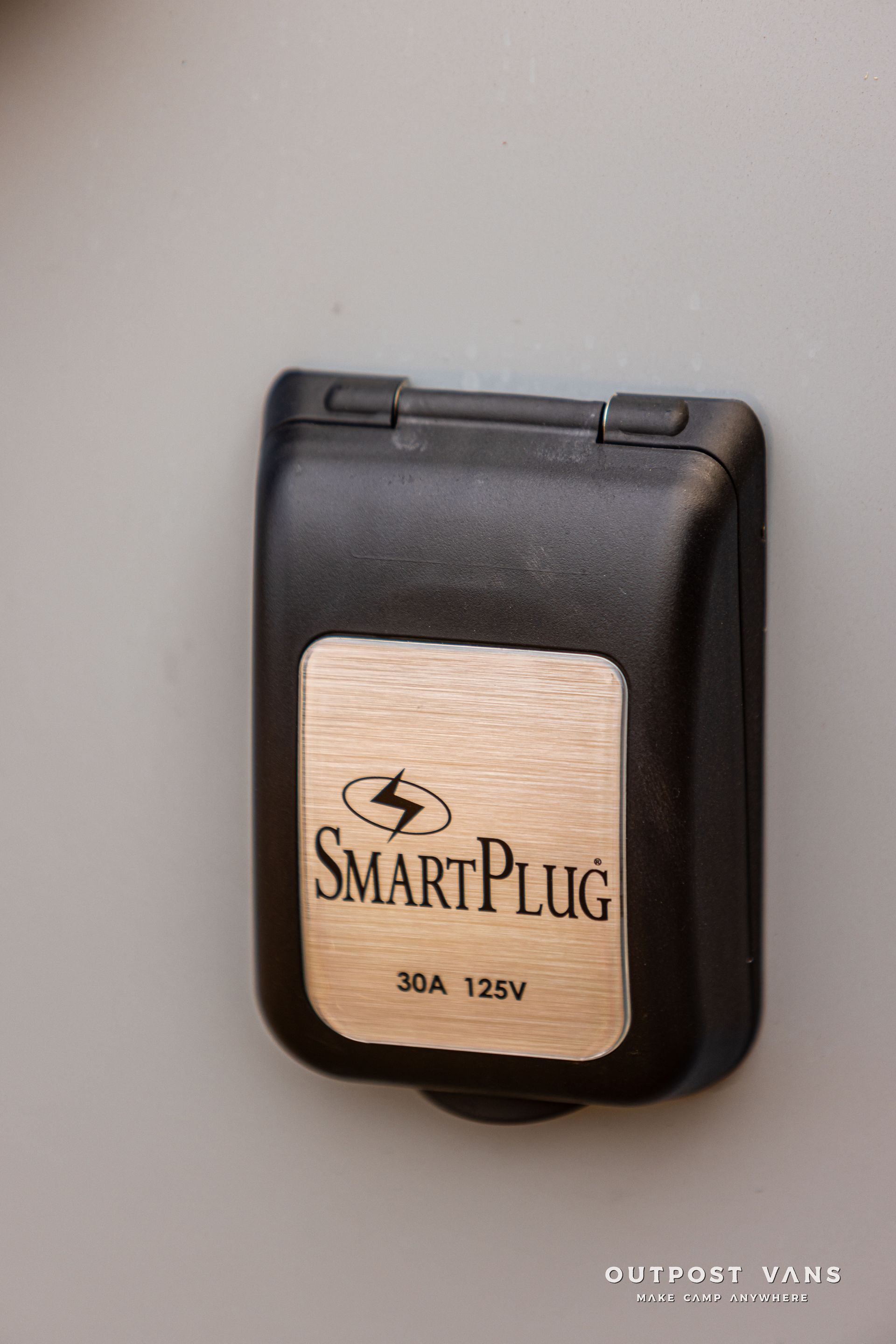 A smart plug is attached to a wall.