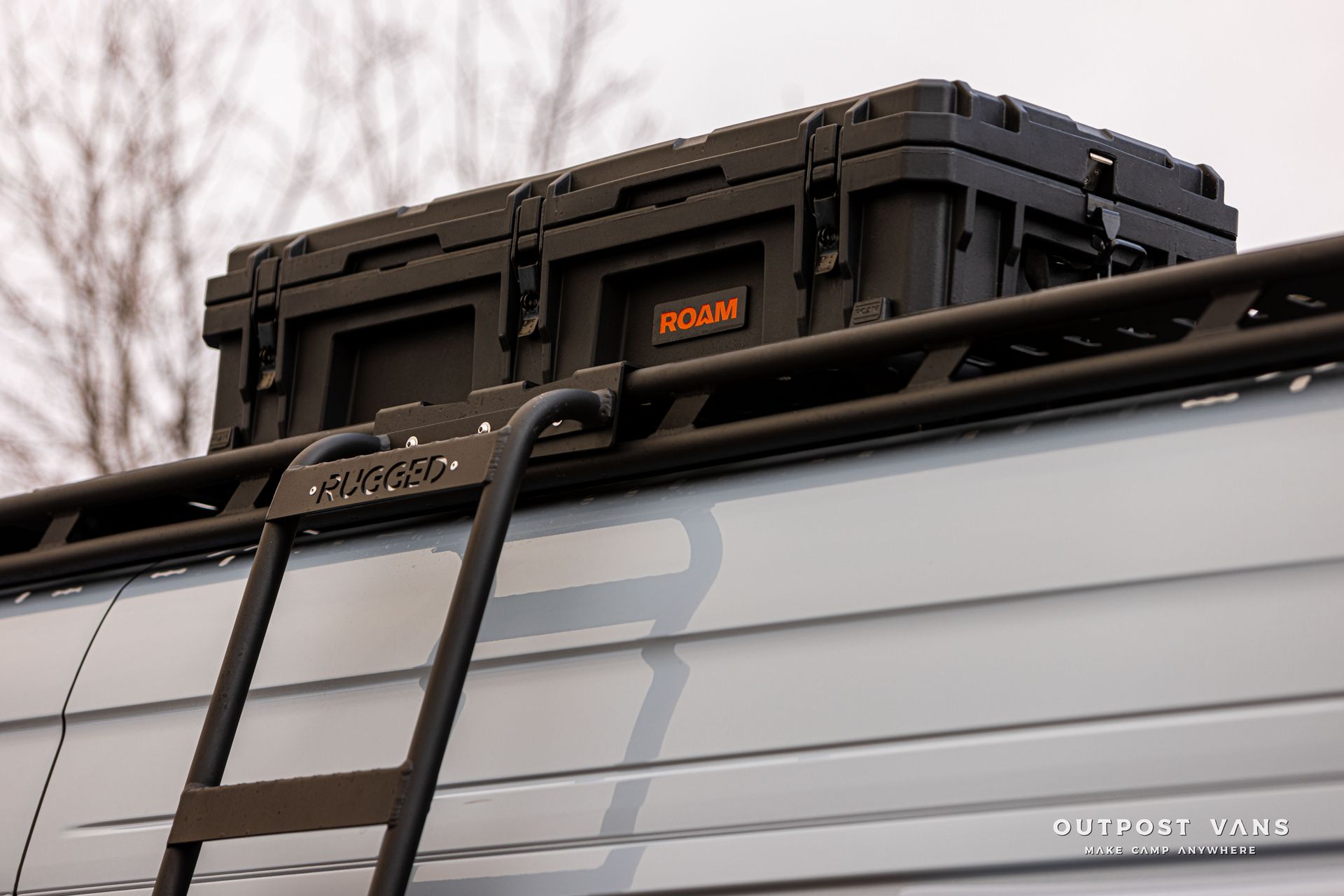 A ladder is attached to the roof of a van.