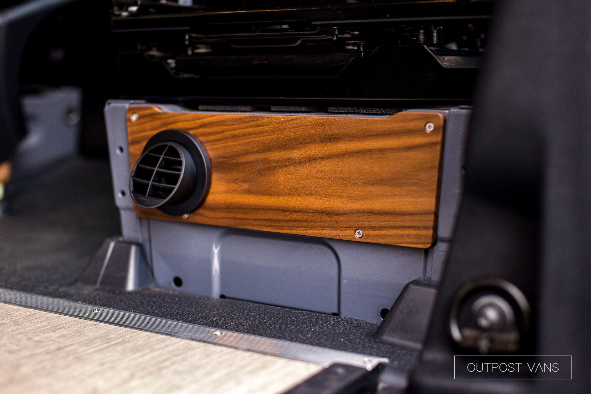 A close up of a wooden heater in a car.