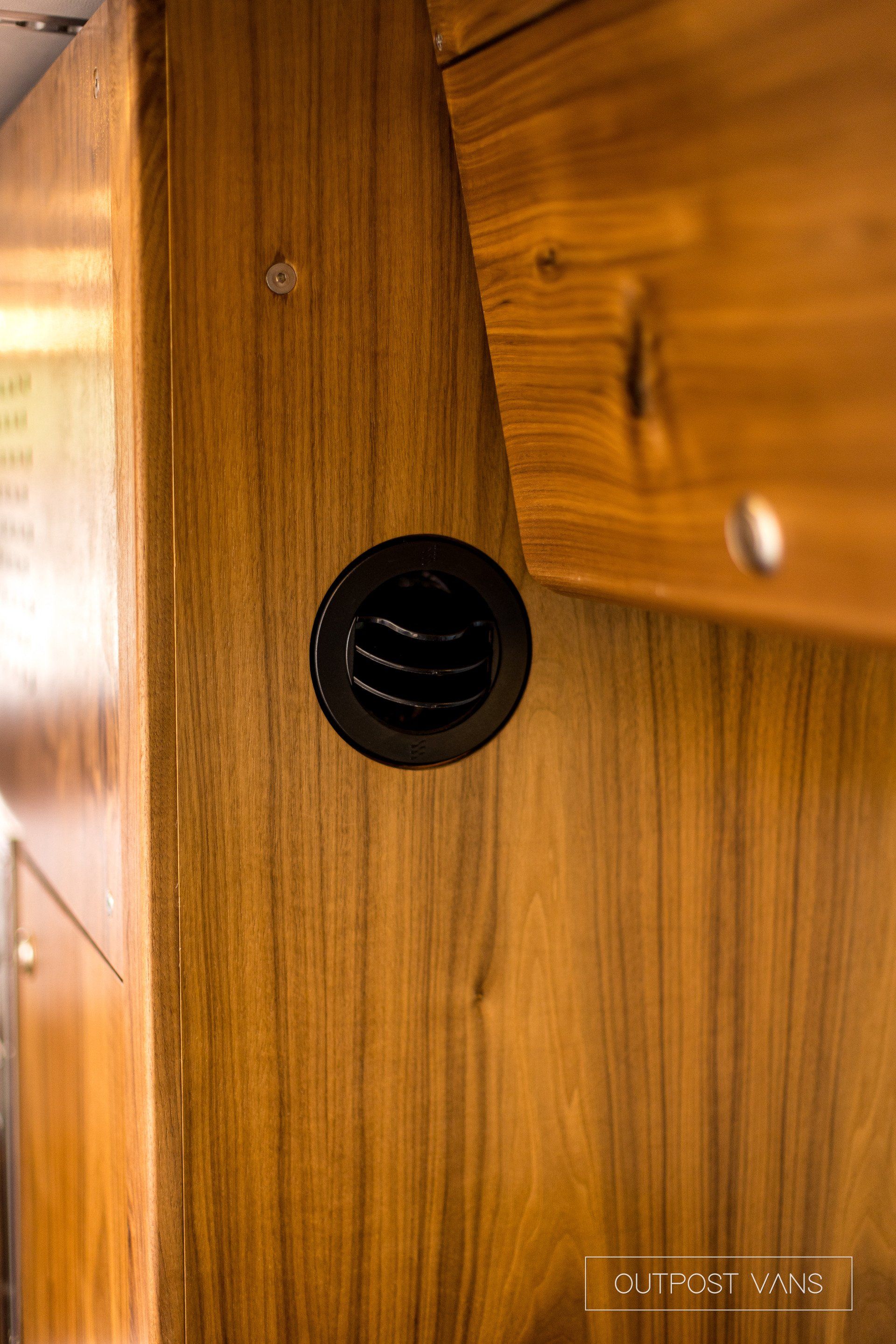 A close up of a wooden wall with a hole in it.