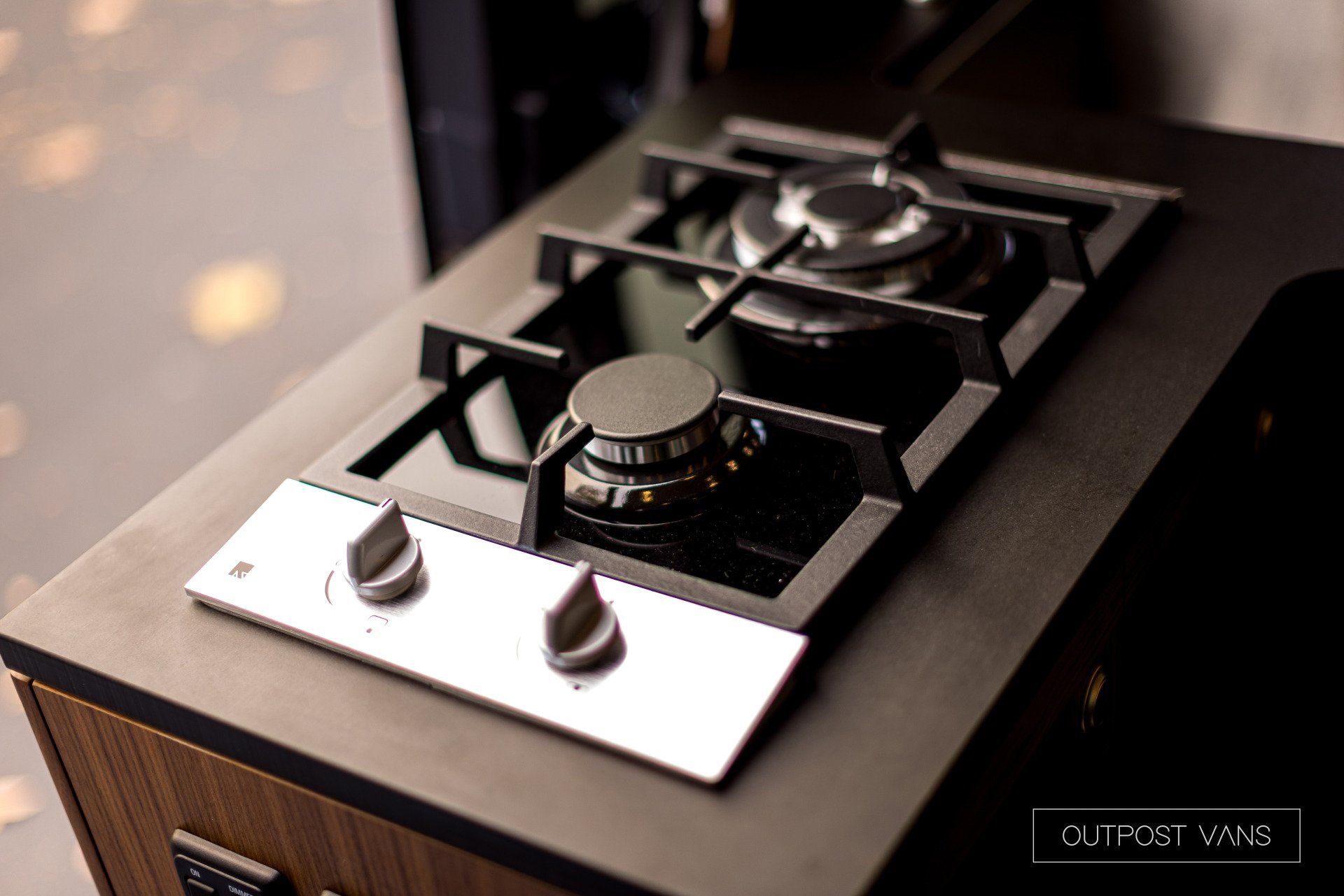 A gas stove is sitting on top of a counter.