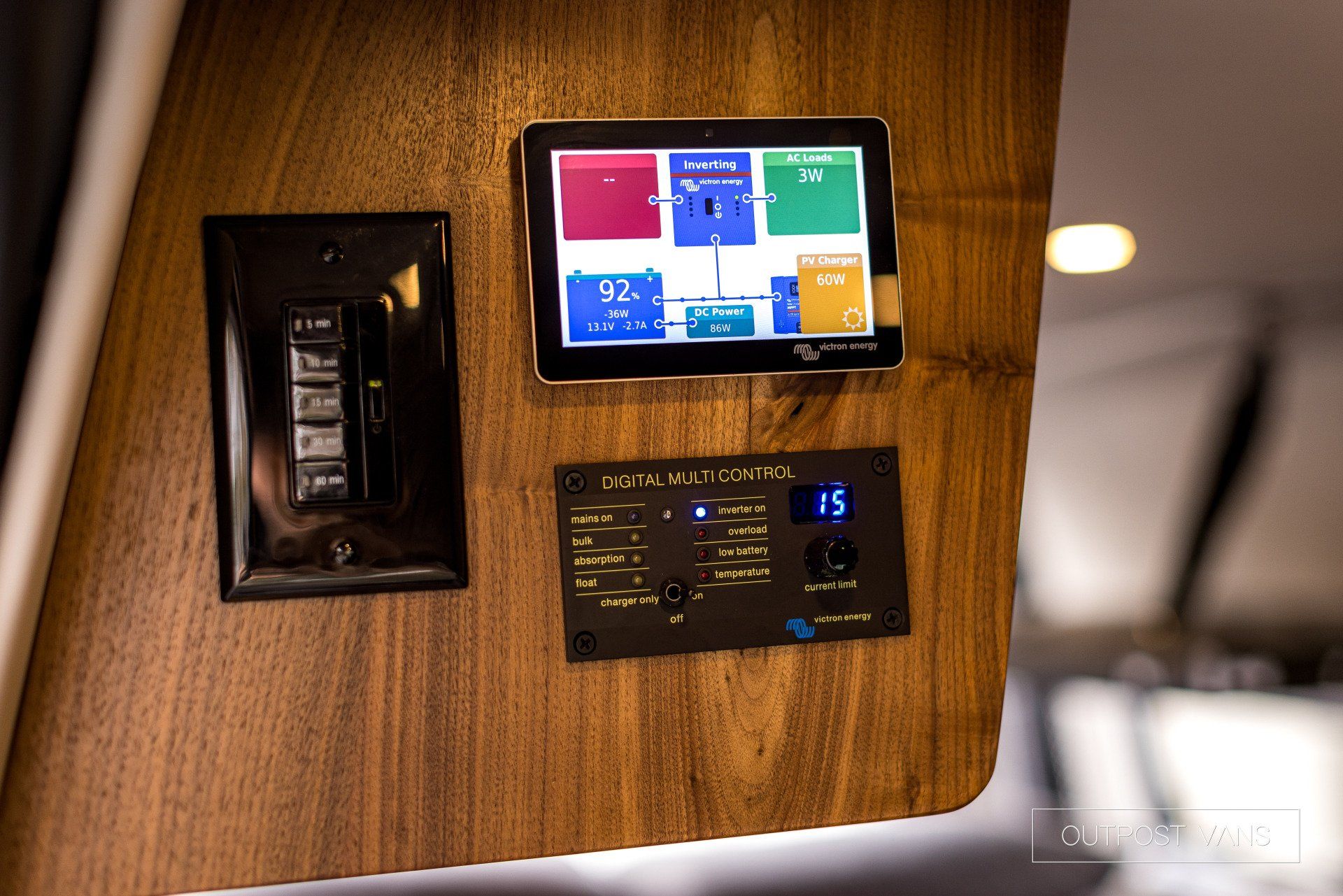 A wooden wall with a tablet and a switch on it