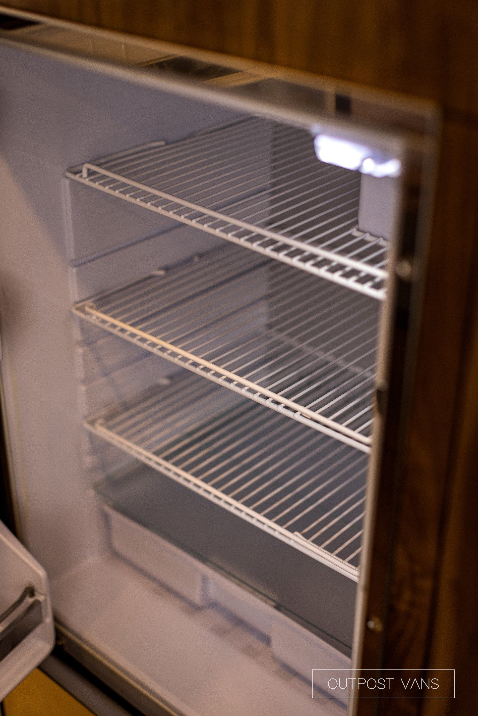 The inside of an empty refrigerator with the door open