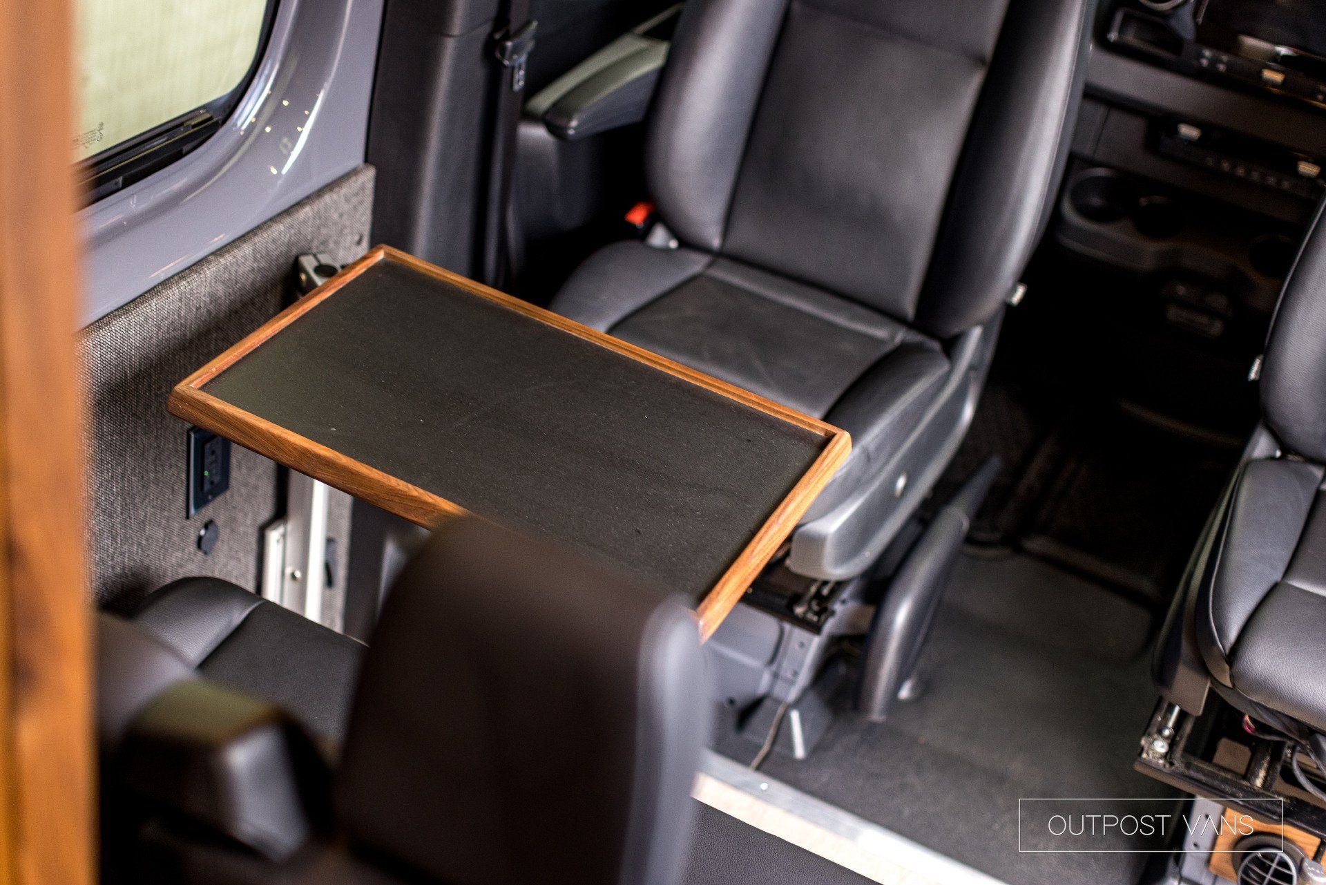 There is a table in the back seat of a van.