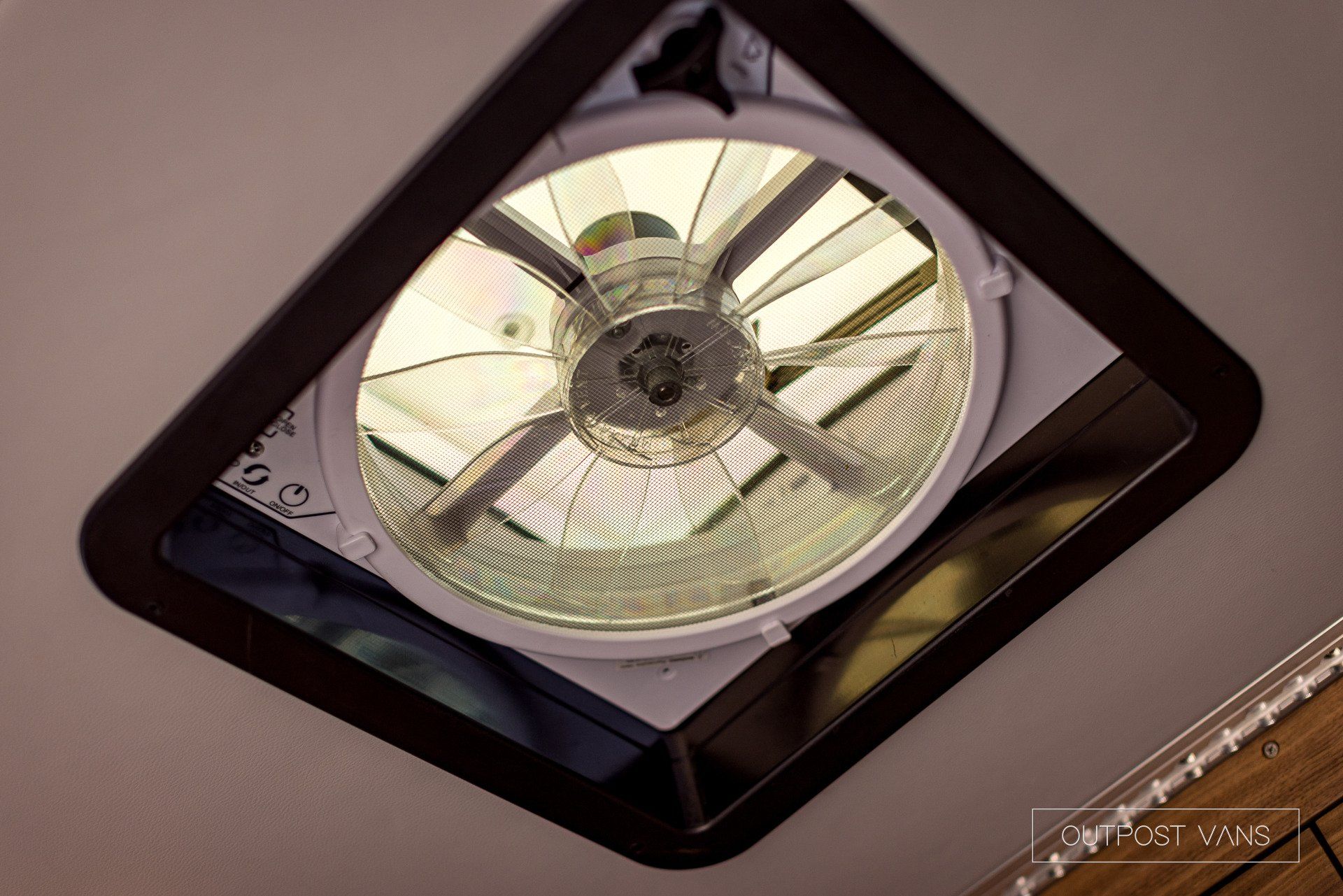 A fan is hanging from the ceiling of a room.