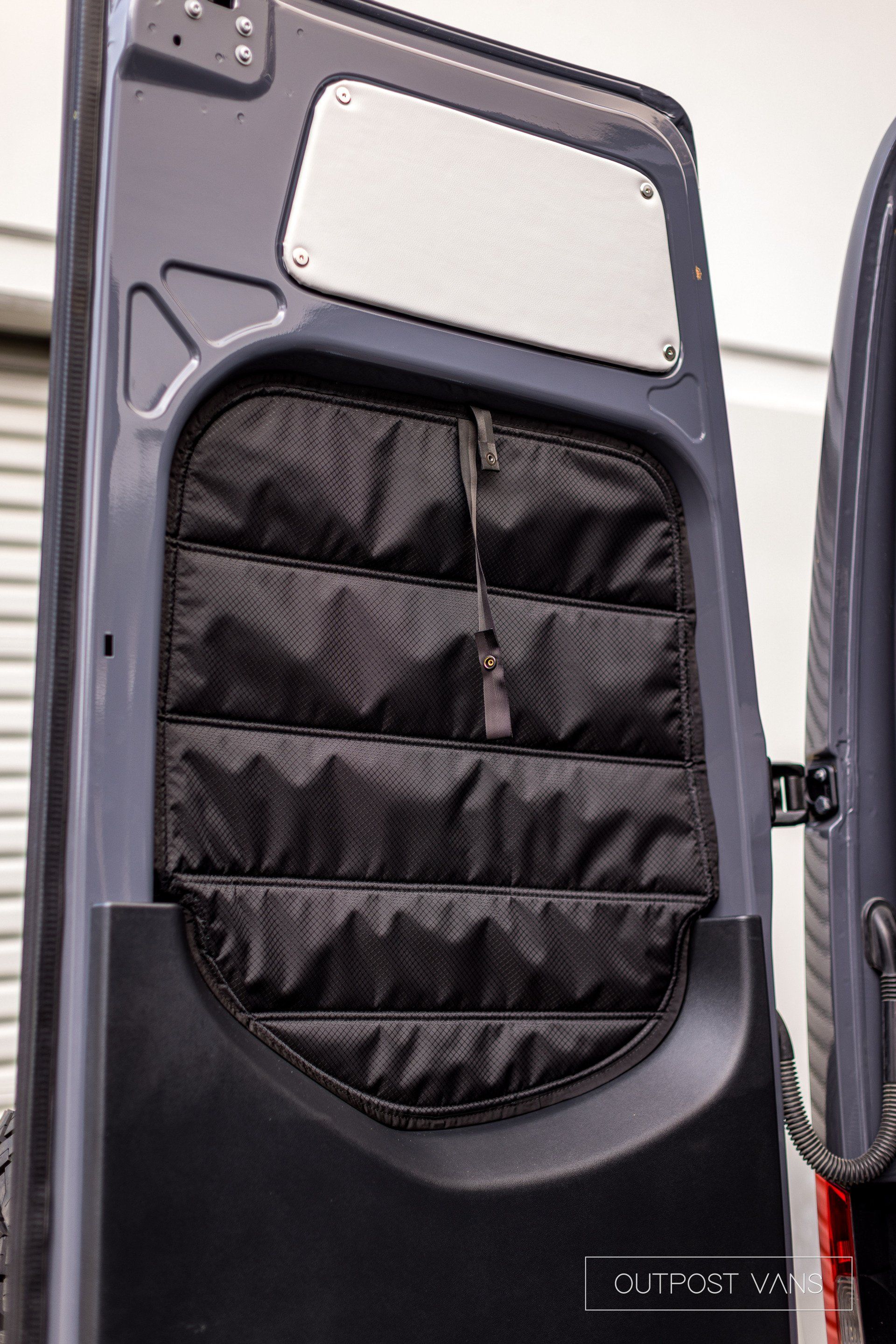 A close up of a van door with a pocket in it.