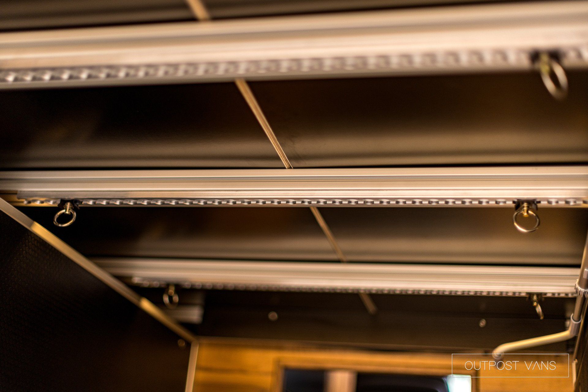 A close up of a ceiling with a lot of lights hanging from it.